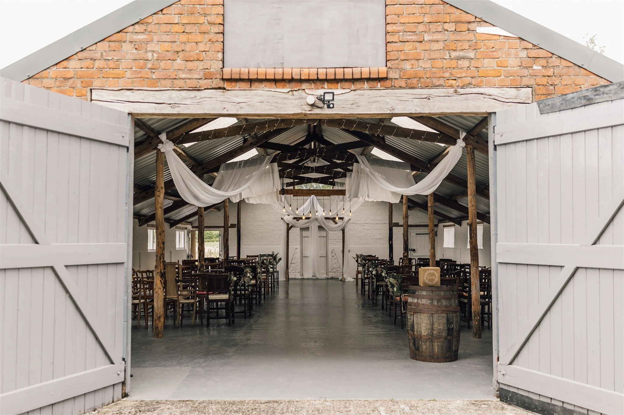 Shot through open barn doors to ceremony room
