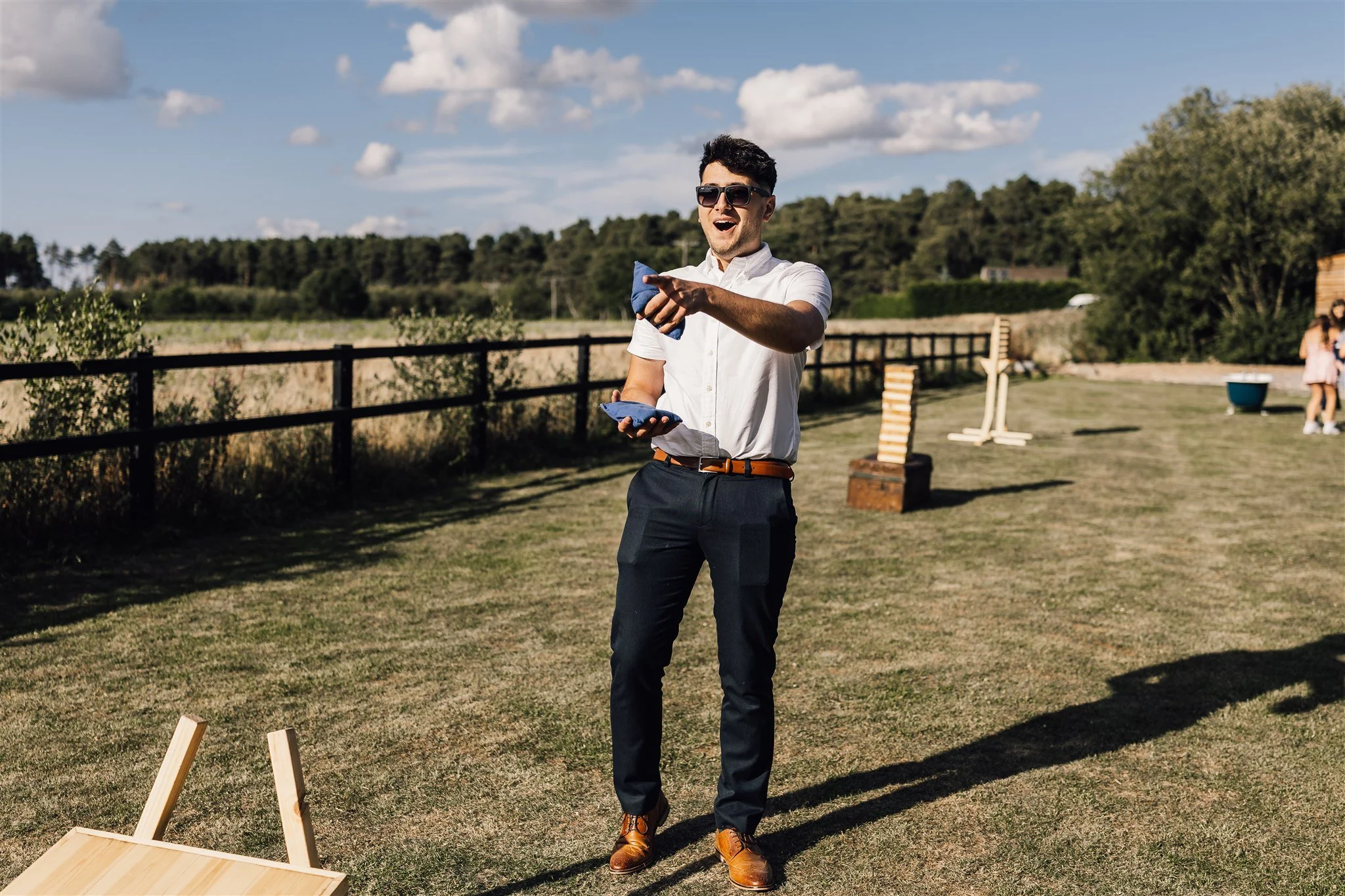 Guest playing garden games at summer wedding white Syke fields