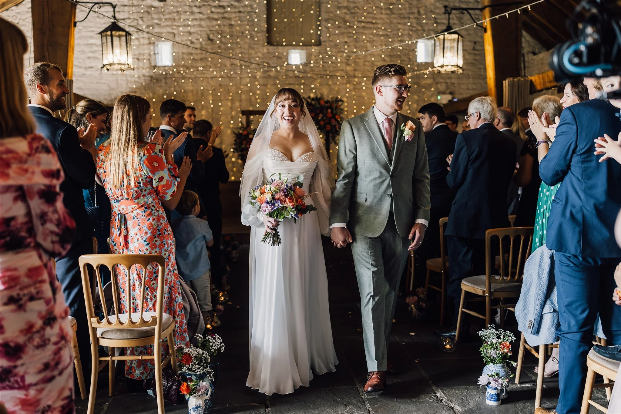 Bride and groom walking down the aisle together after ceremony at East Riddlesden Hall