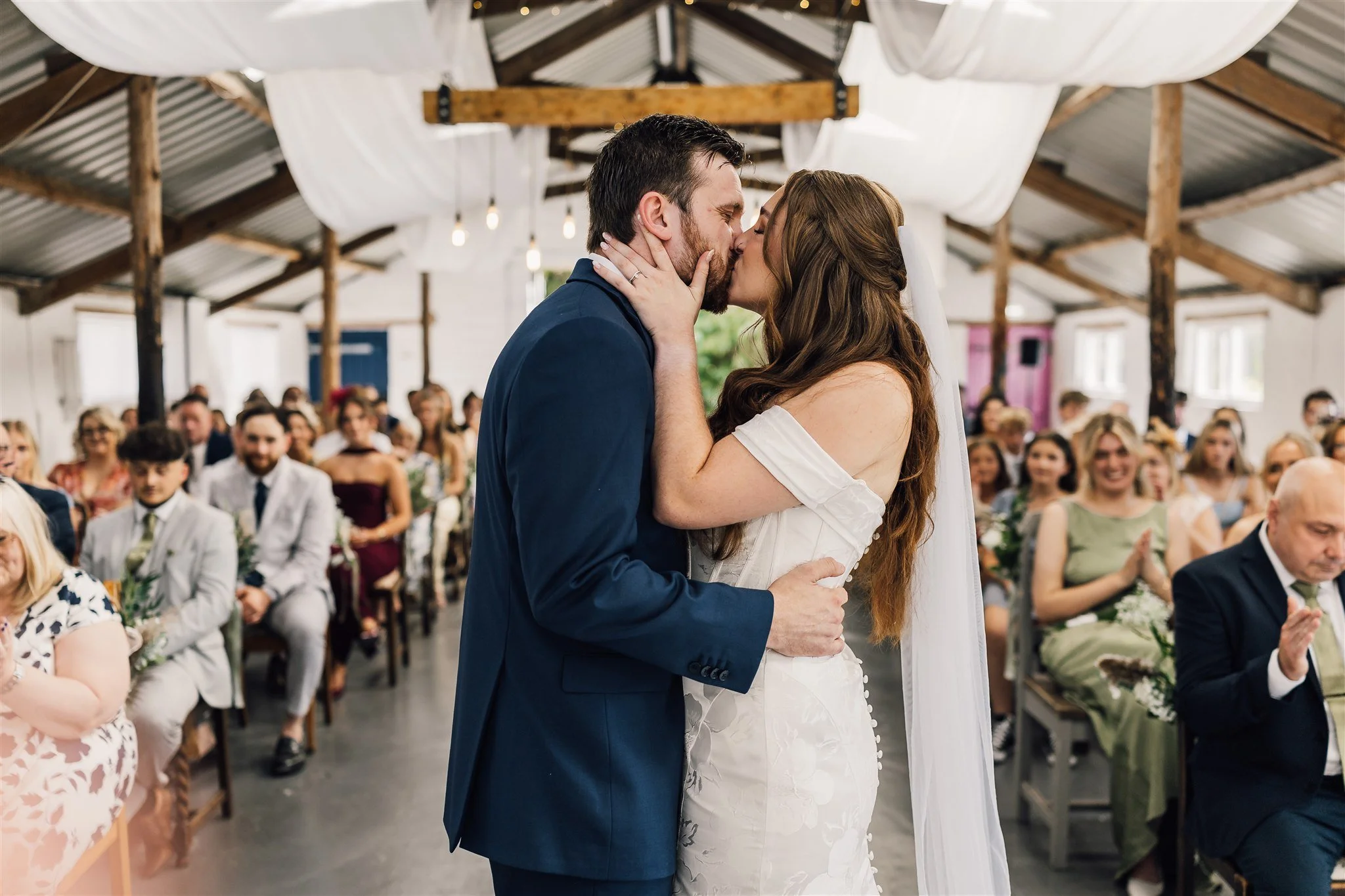Birde & Groom kissing inside the piggery white Syke fields