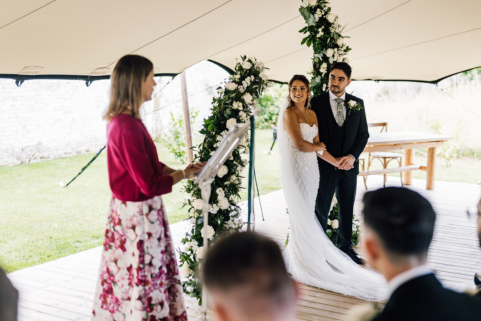 Charlotte and Rory with their registrar during the covered outdoor ceremony