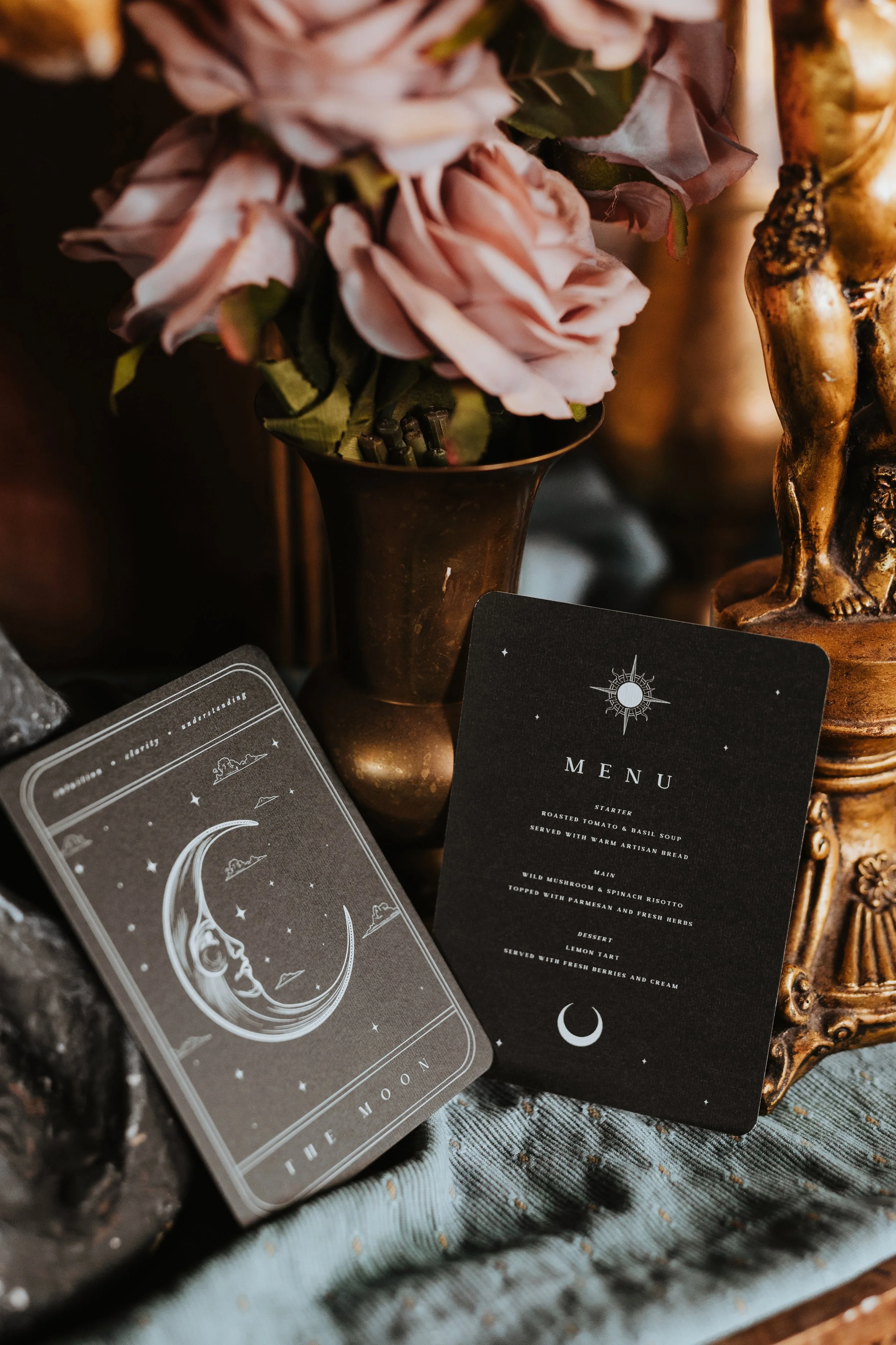 Dark alternative wedding styling with celestial themed stationery and decor