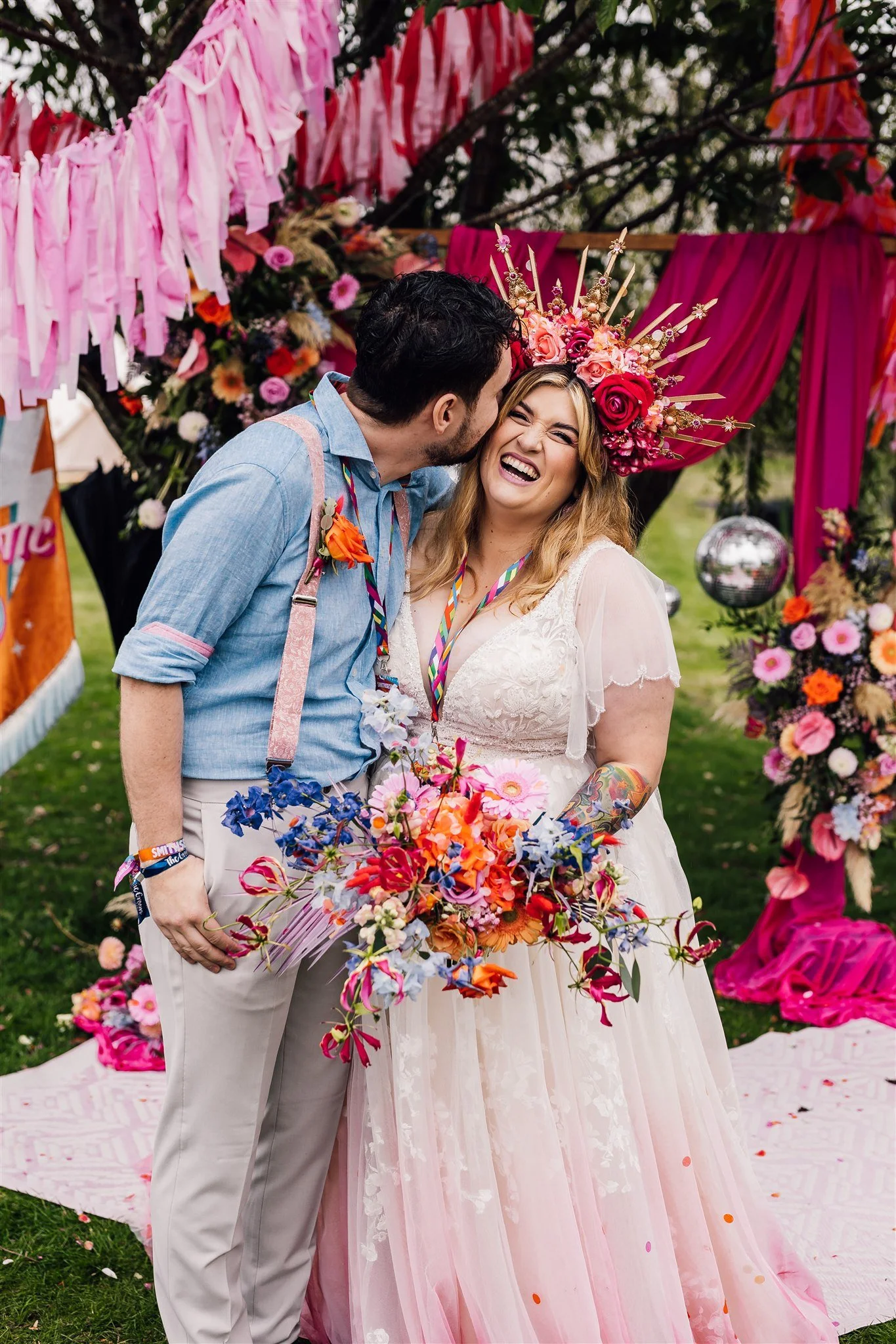 A couple laughing together at their colourful wedding celebration at Pitch 21