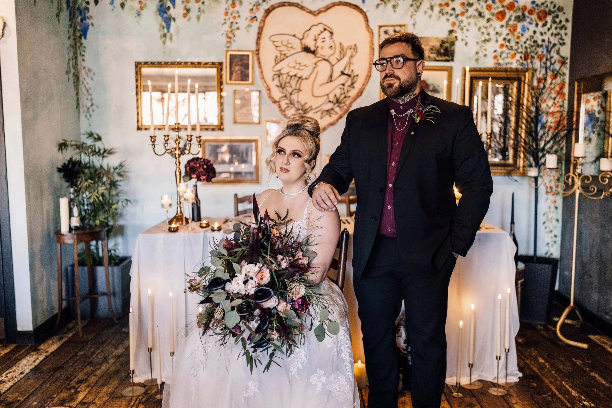 Alternative wedding couple portrait with romantic candlelit styling and vintage decor