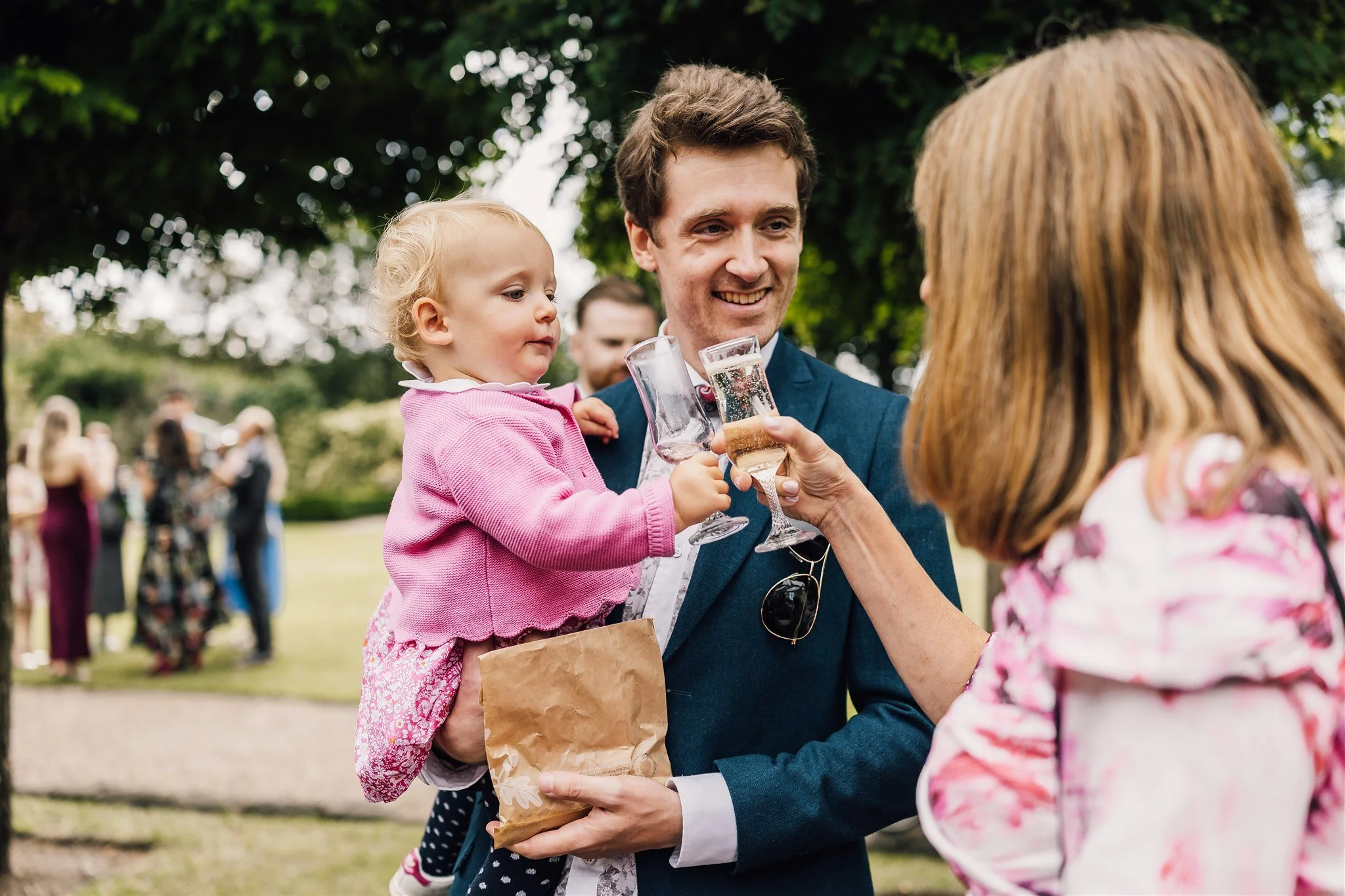 Wedding guests enjoying drinks and chatting outside at East Riddlesden Hall