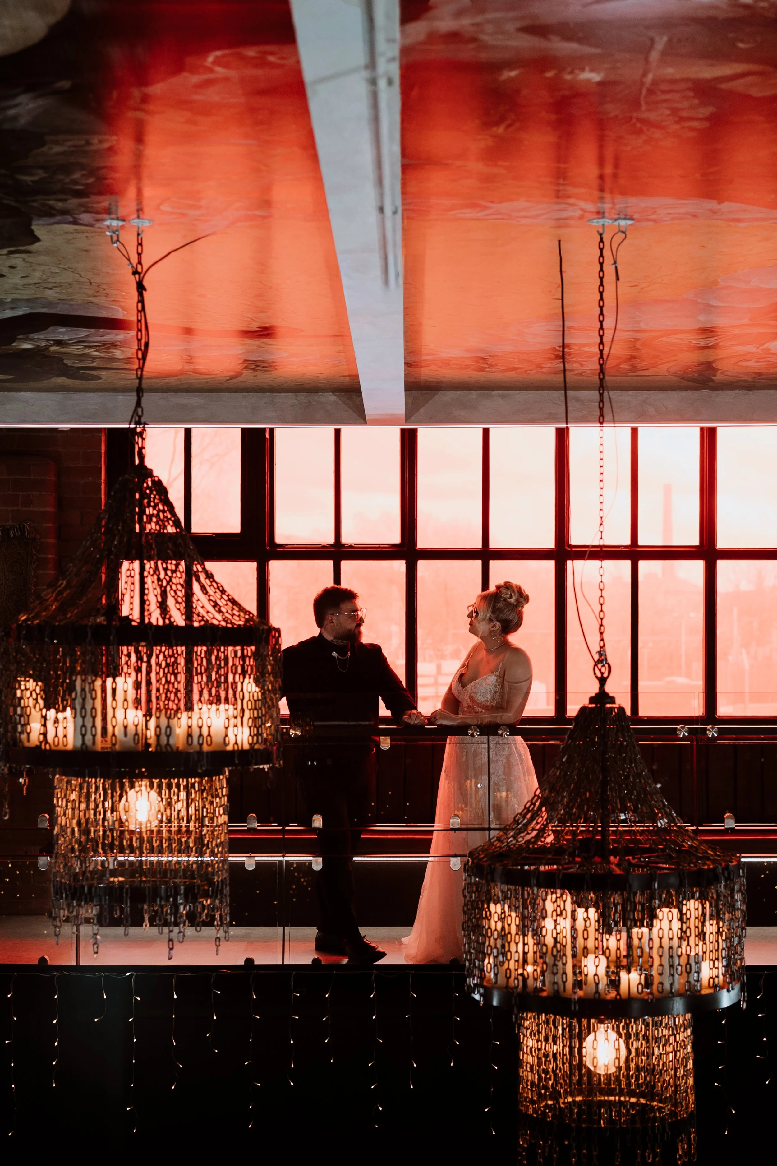 Alternative wedding couple under chandeliers at Church Temple of Fun Sheffield wedding