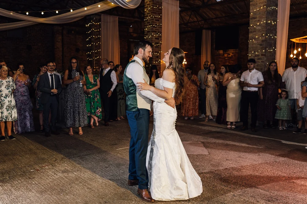 Lauren and Ben sharing their first dance beneath fairy lights at White Syke Fields