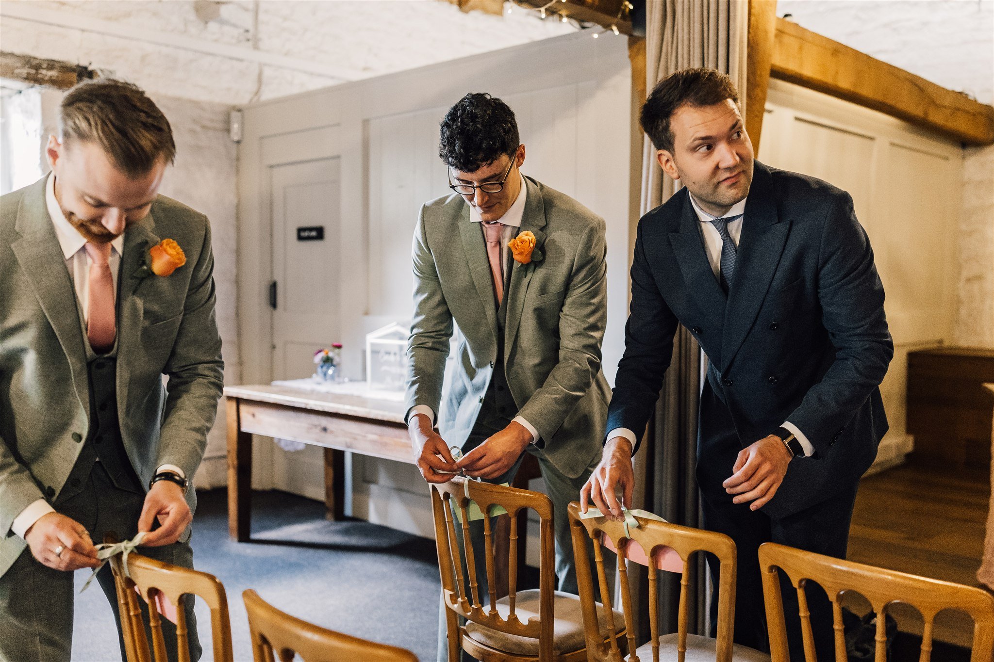 Groomsmen preparing ceremony space at East Riddlesden Hall wedding venue in West Yorkshire