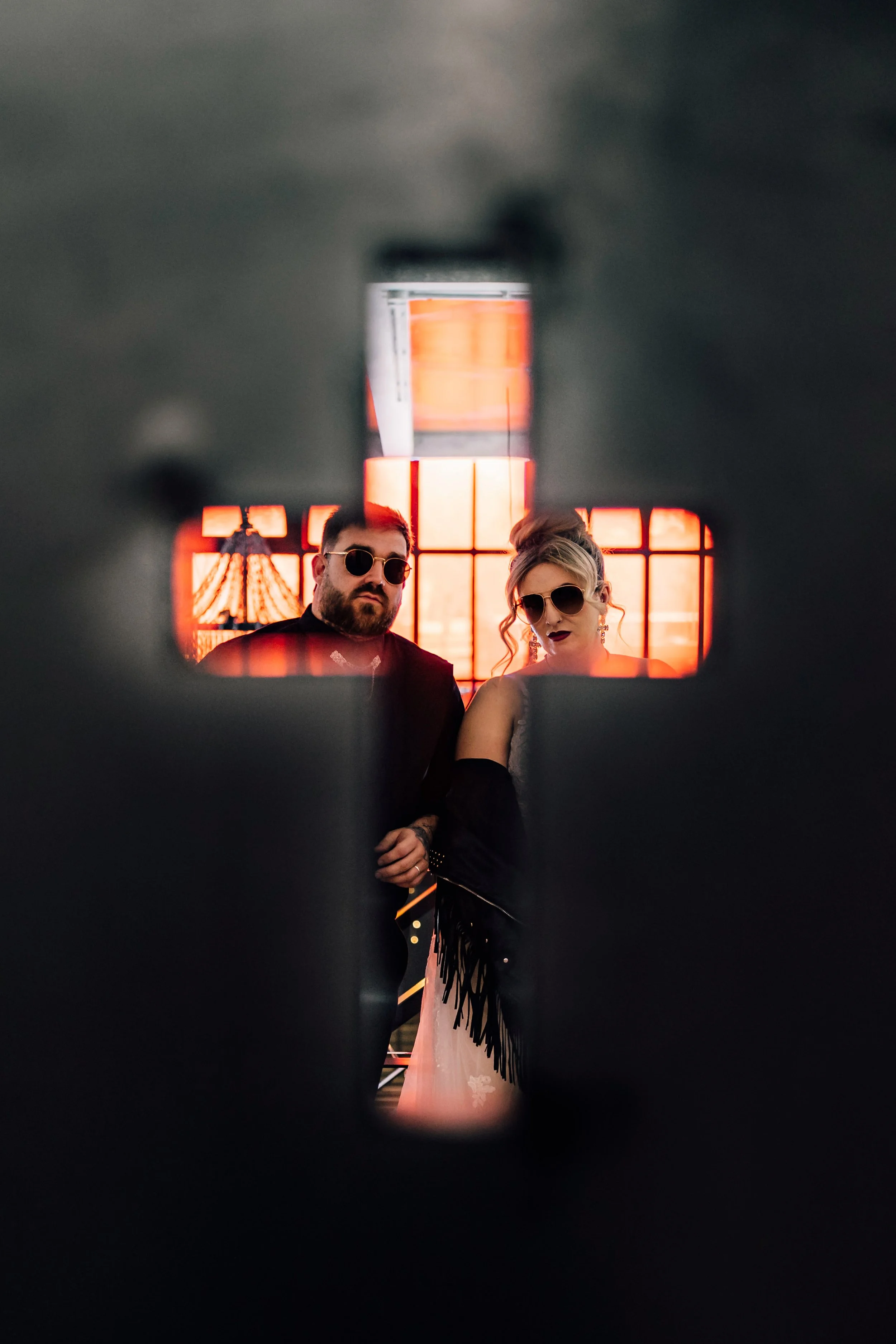 Creative couple portrait framed through cross at Church Temple of Fun wedding Sheffield