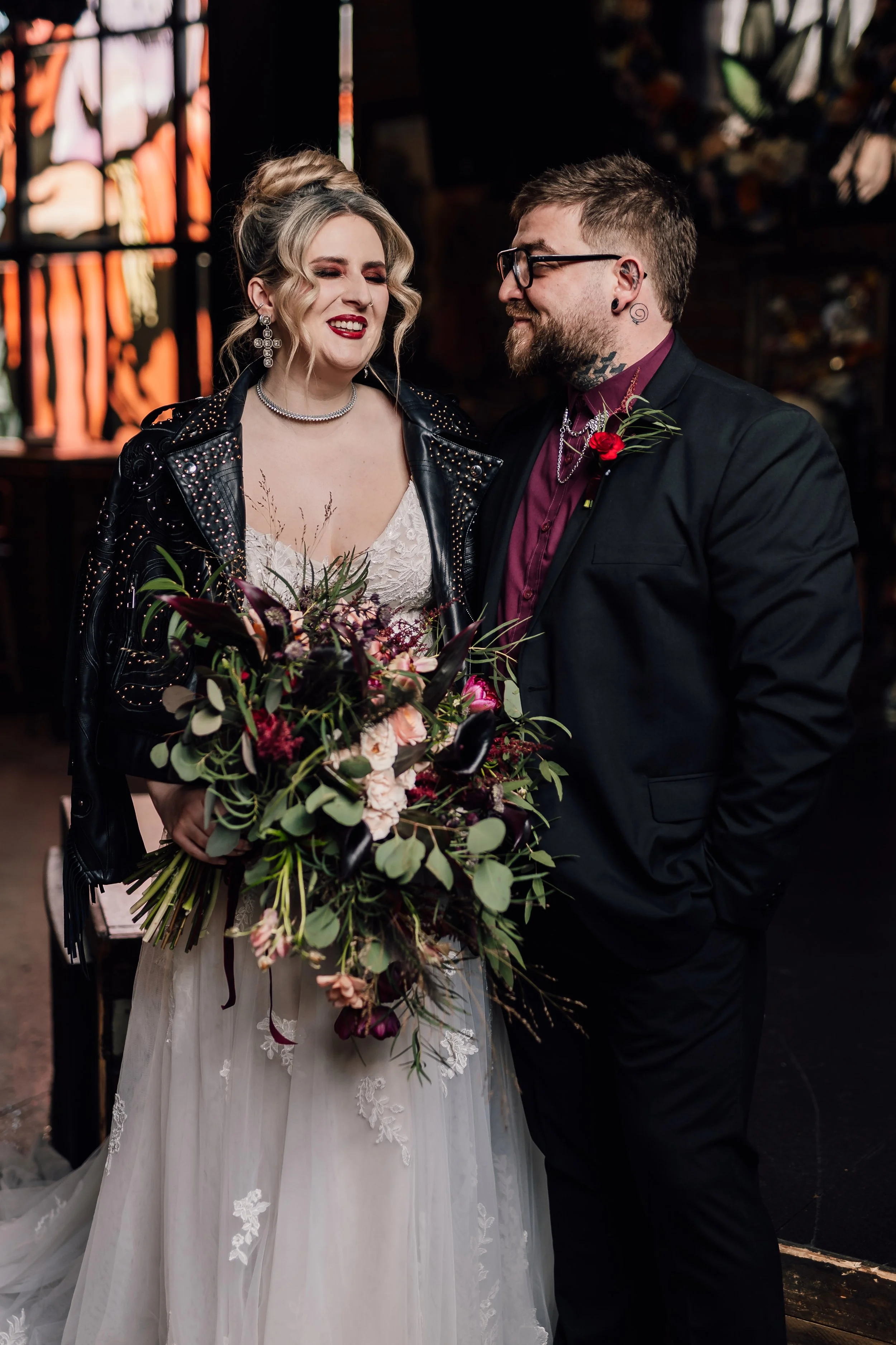 Alternative wedding couple portrait with dramatic bouquet and dark romantic styling