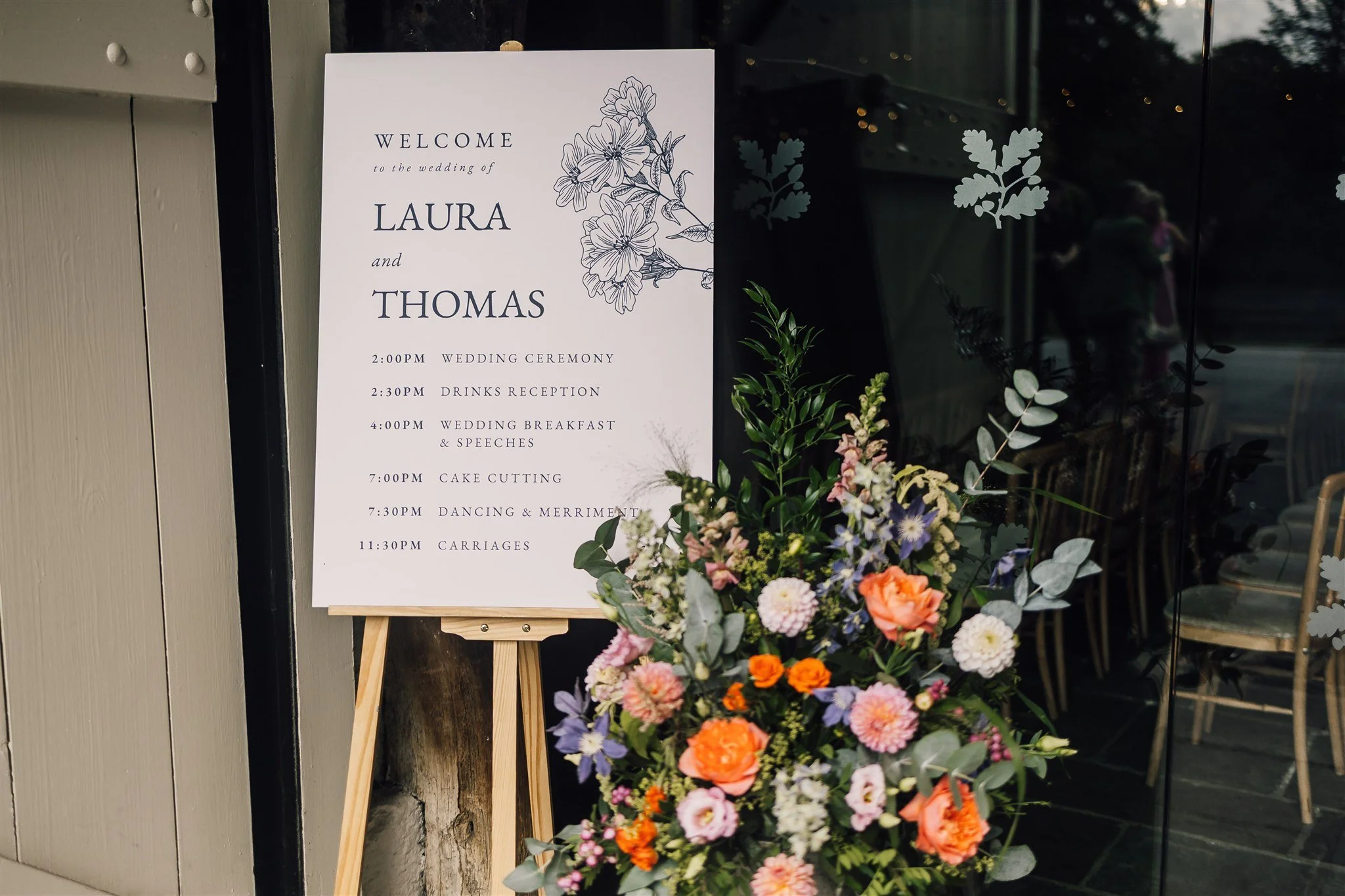 Wedding welcome sign and floral arrangement at East Riddlesden Hall in West Yorkshire