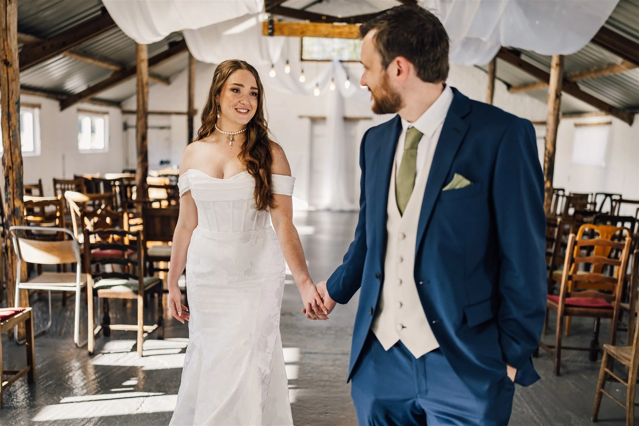 Bride and groom walking through The Piggery White Syke Fields