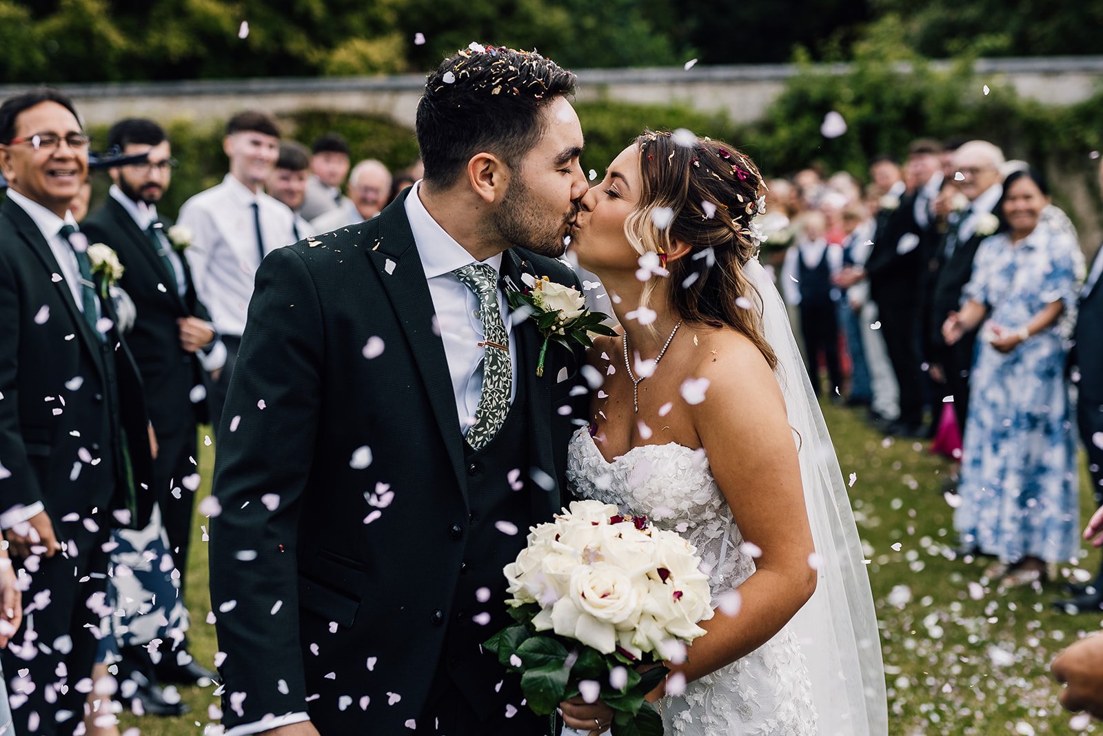 Charlotte and Rory kissing as guests throw confetti