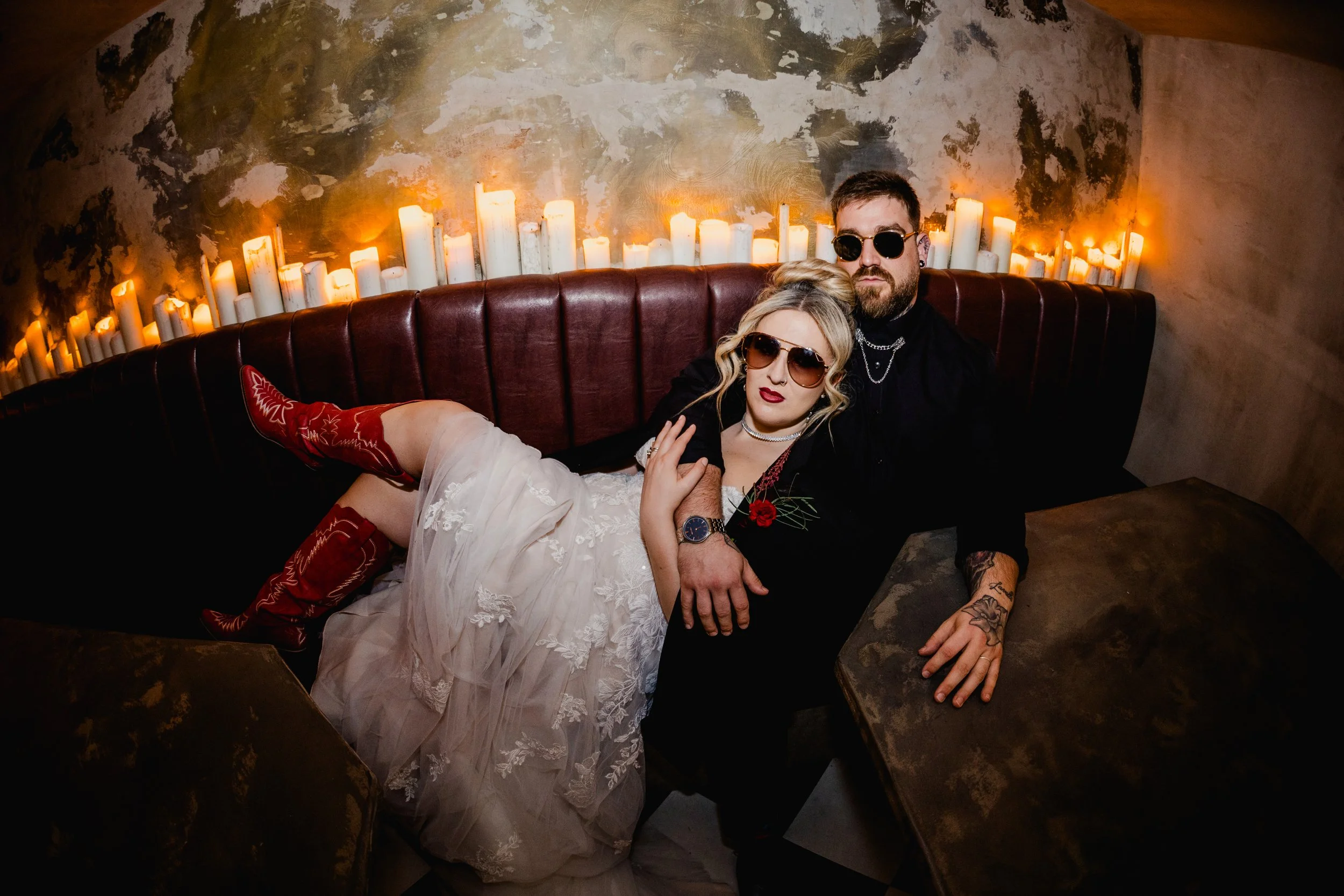 Alternative wedding couple relaxing in candlelit booth at Church Temple of Fun Sheffield
