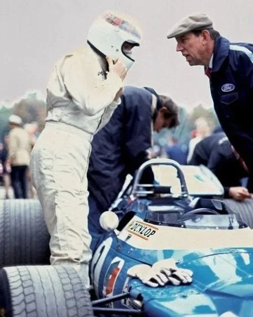 Jackie Stewart and Ken Tyrrell talk over the top of the Matra MS80.