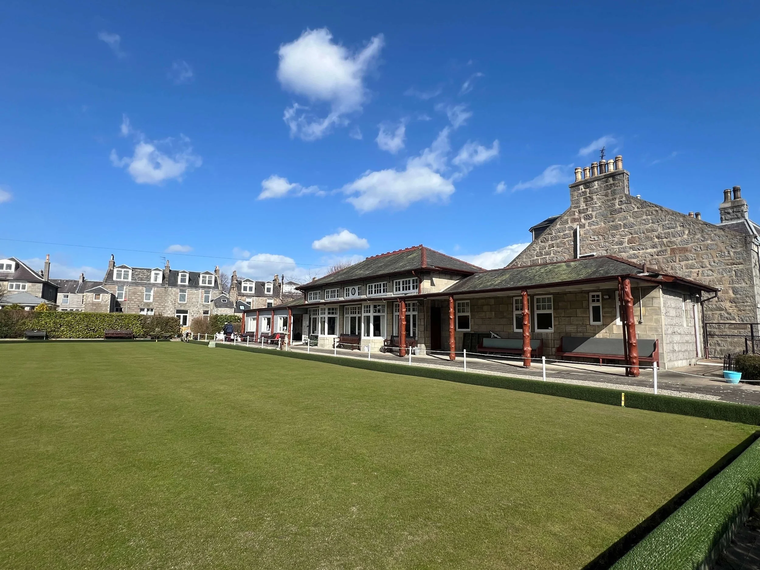 The Aberdeen Bowling Club building and the green on a sunny day.