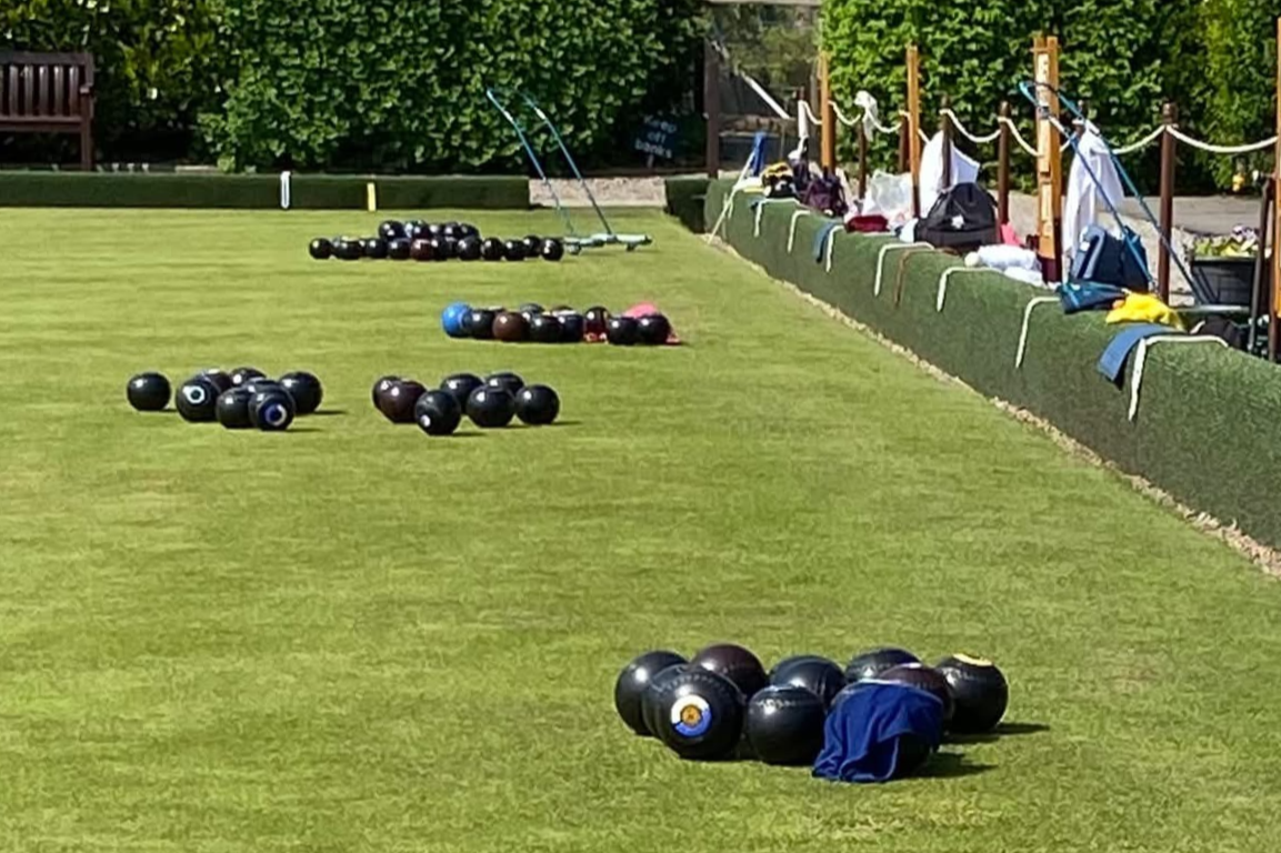 Piles of lawn bowls on a green