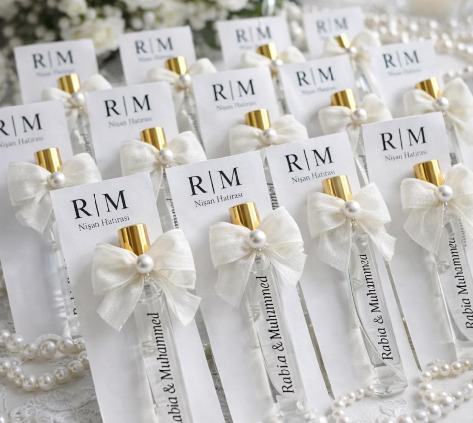 Custom perfume wedding favors displayed on a reception table.