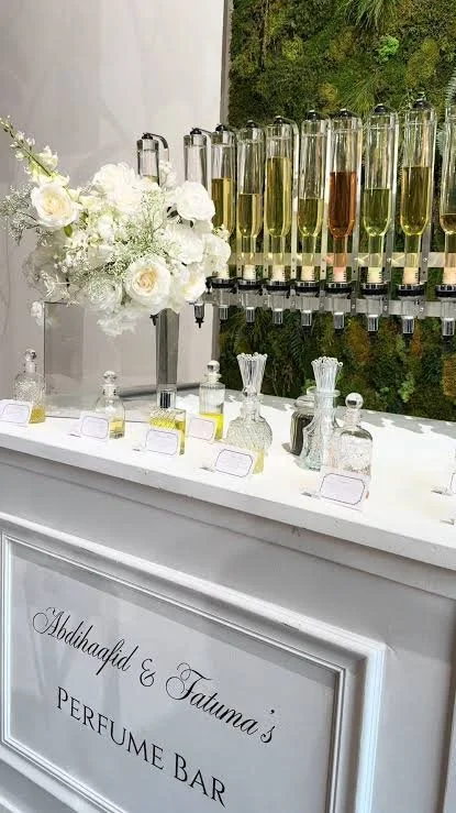 Perfume bar setup with fragrance dispensers at a luxury event.