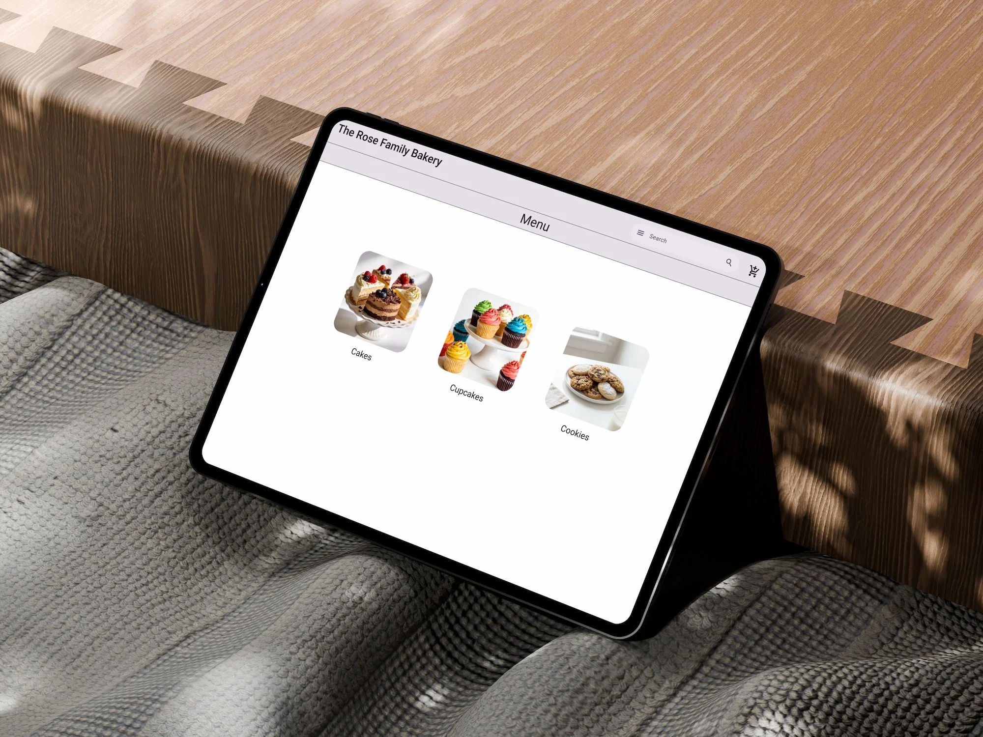 Tablet displaying a bakery website with categories for cakes, cupcakes, and cookies.