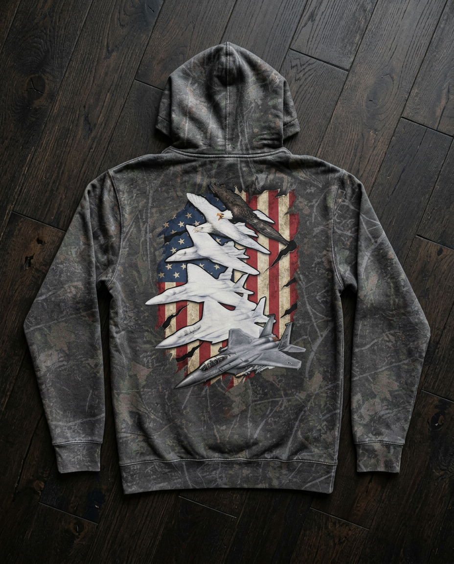 Gray camouflage hooded sweatshirt with graphic artwork of military jets and eagle over an American flag background.