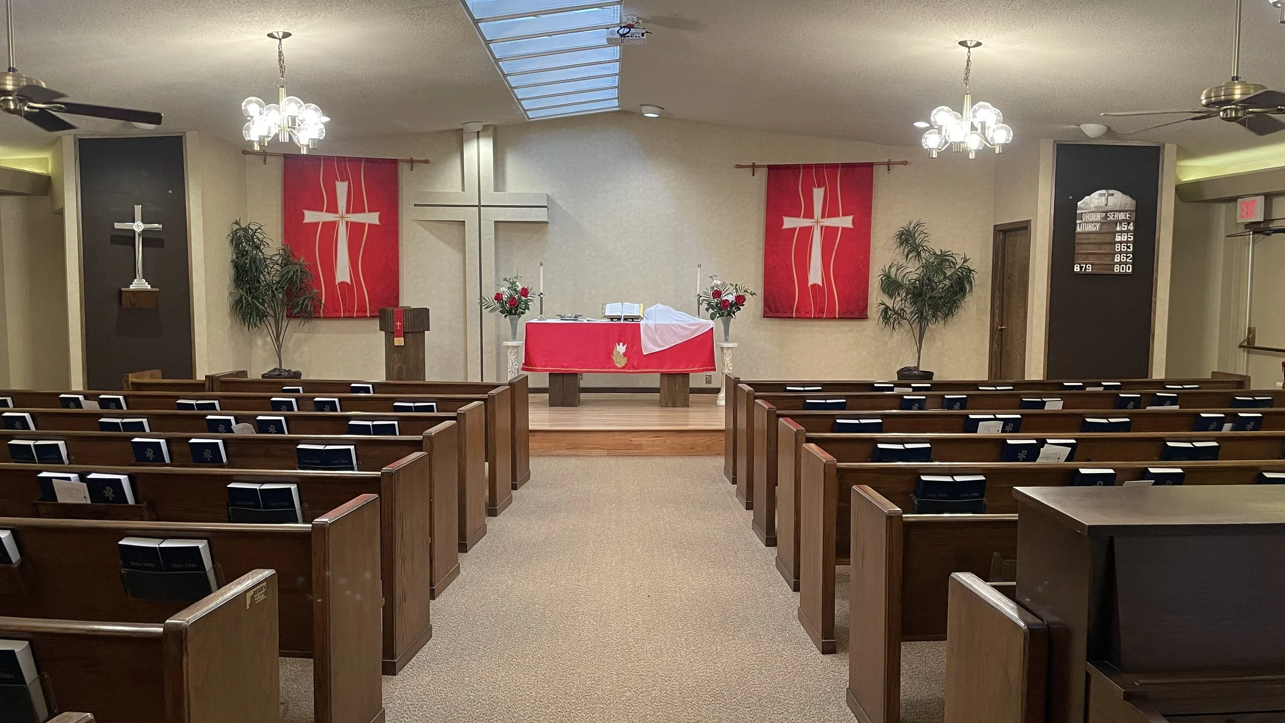 picture of the pews and front altar in a church with red banners