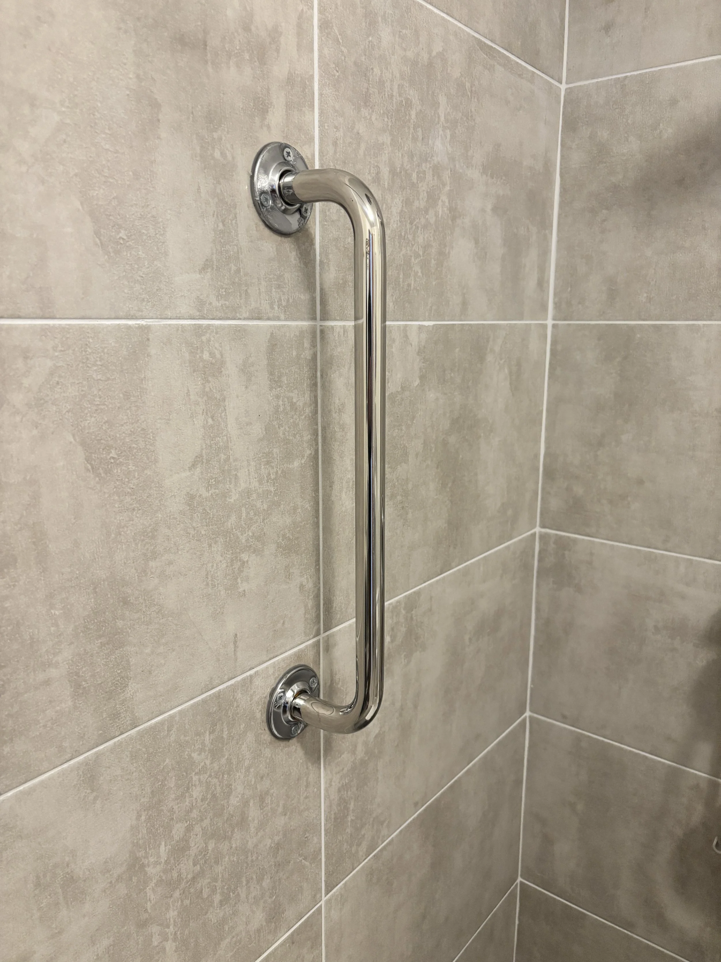Chrome grab rail fitted beautifully into a shower