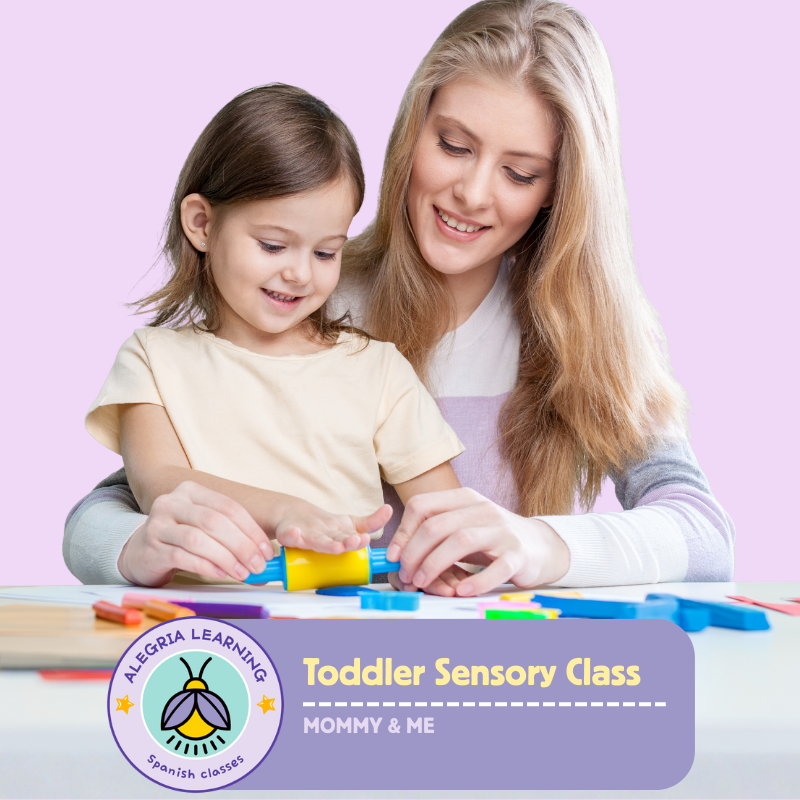 A woman and a young girl playing with colorful educational toys at a table for a toddler sensory class.
