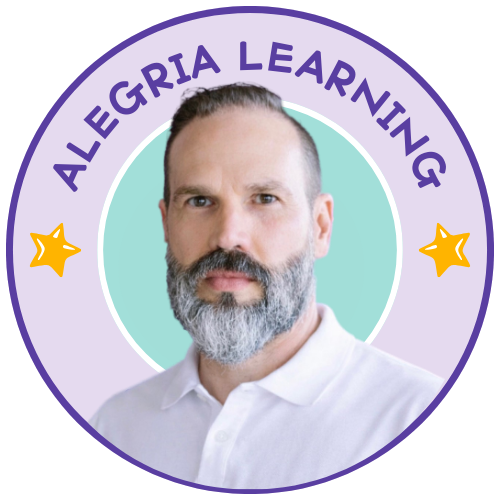 Portrait of a man with a beard and mustache, wearing a white collared shirt, against a pastel green background surrounded by a purple circular badge with yellow stars and the text 'Allegoria Learning'.