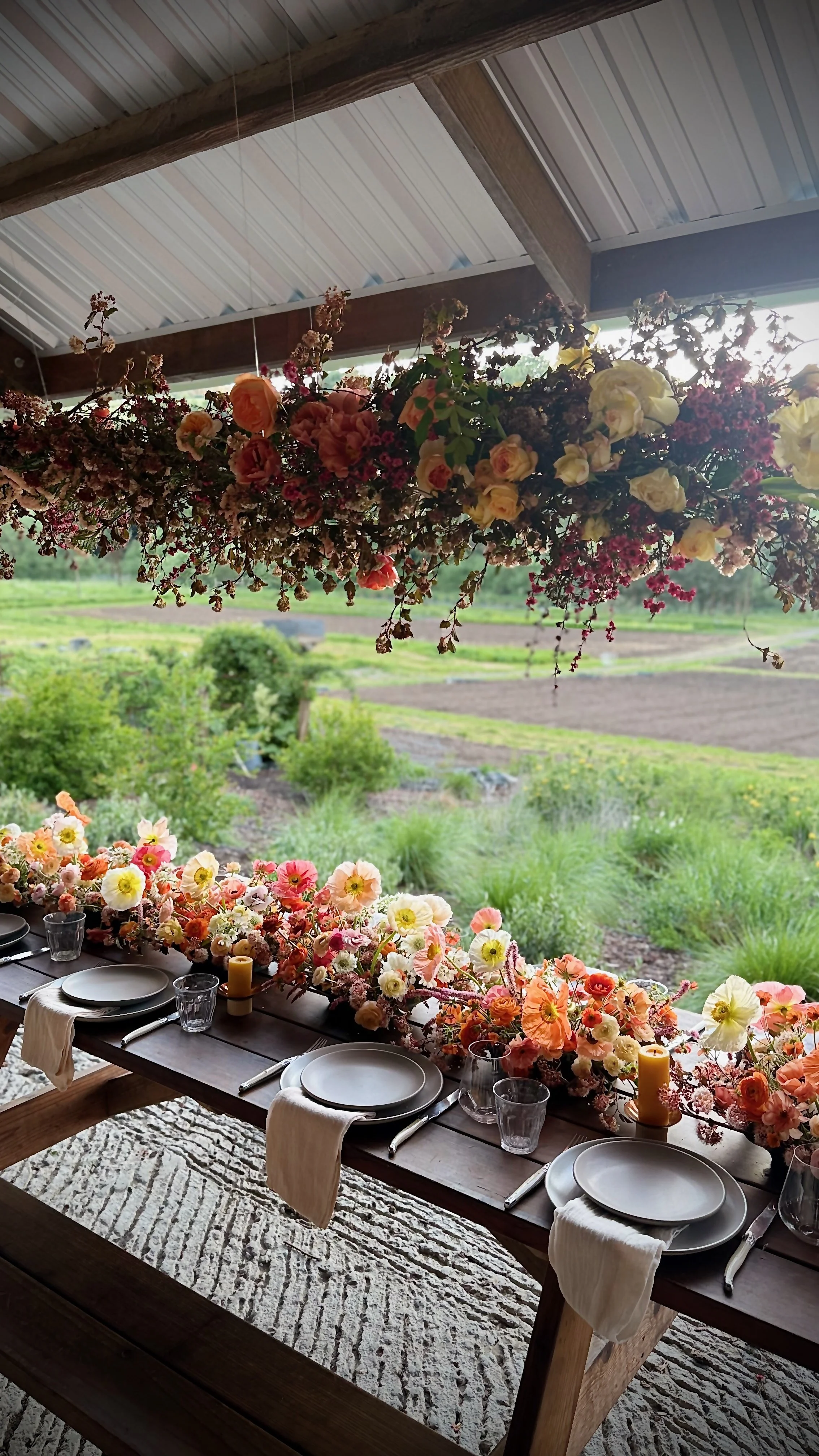 Farm table with floral hanging installation and floral runner from organic, locally grown blooms