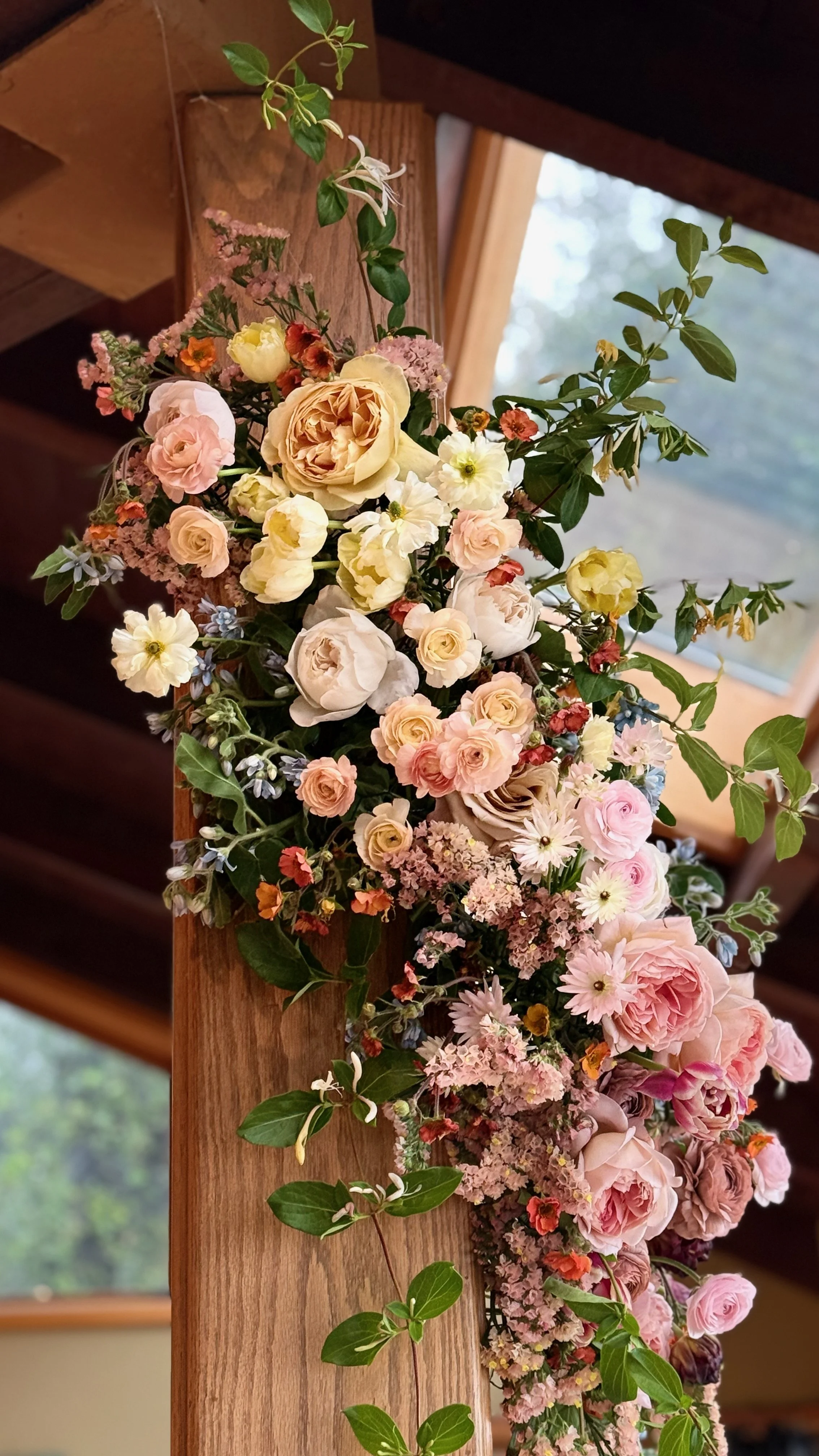 Floral installation featuring local sustainably grown roses and ranunculus Aspen Colorado