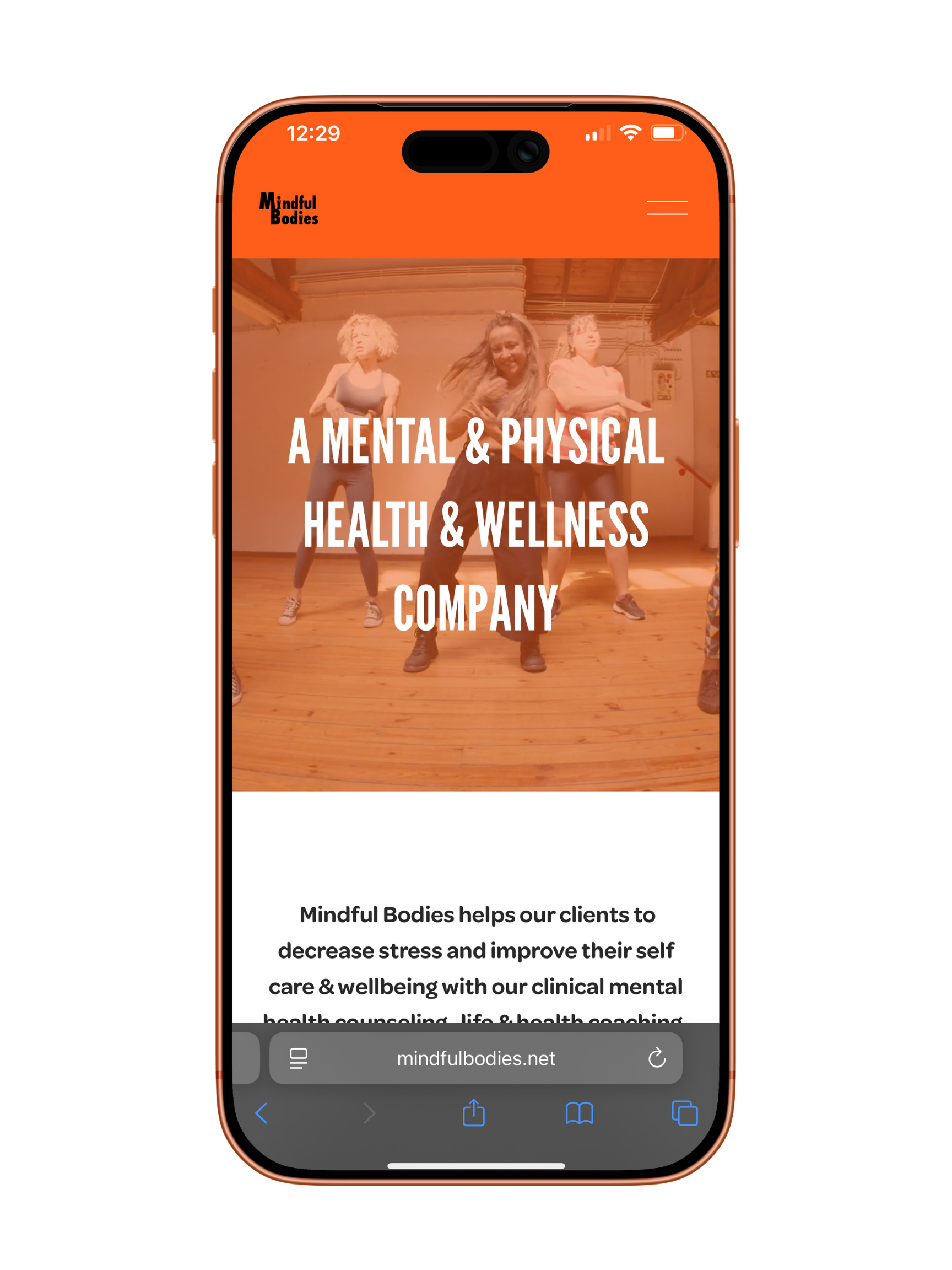 Mobile phone displaying the homepage of Mindful Bodies, a mental and physical health wellness company, with a background image of people dancing in a studio.