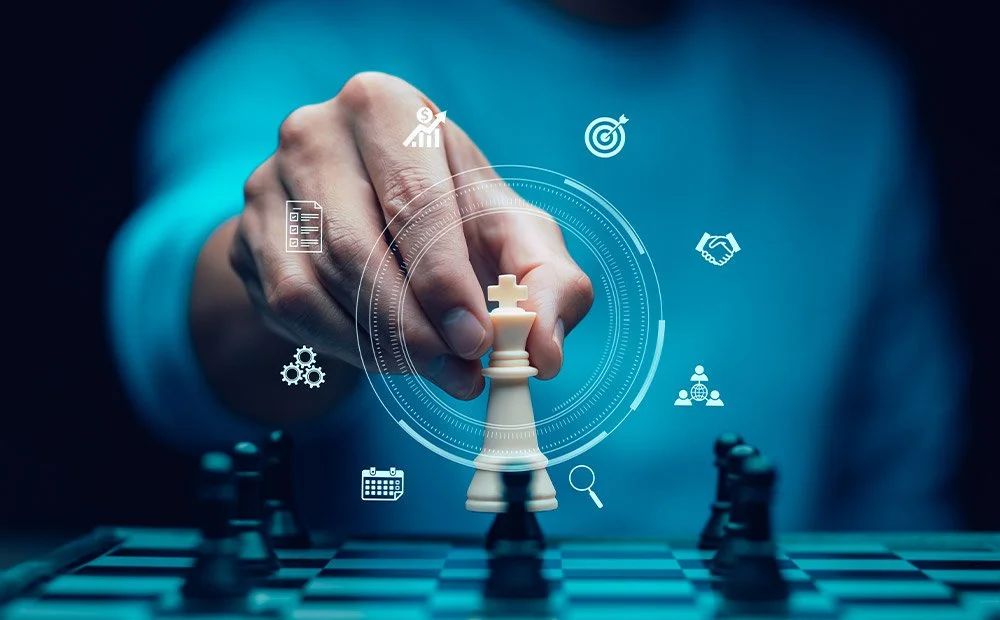 Person moving a white king chess piece on a chessboard with digital icons around it representing strategy, success, planning, and growth.