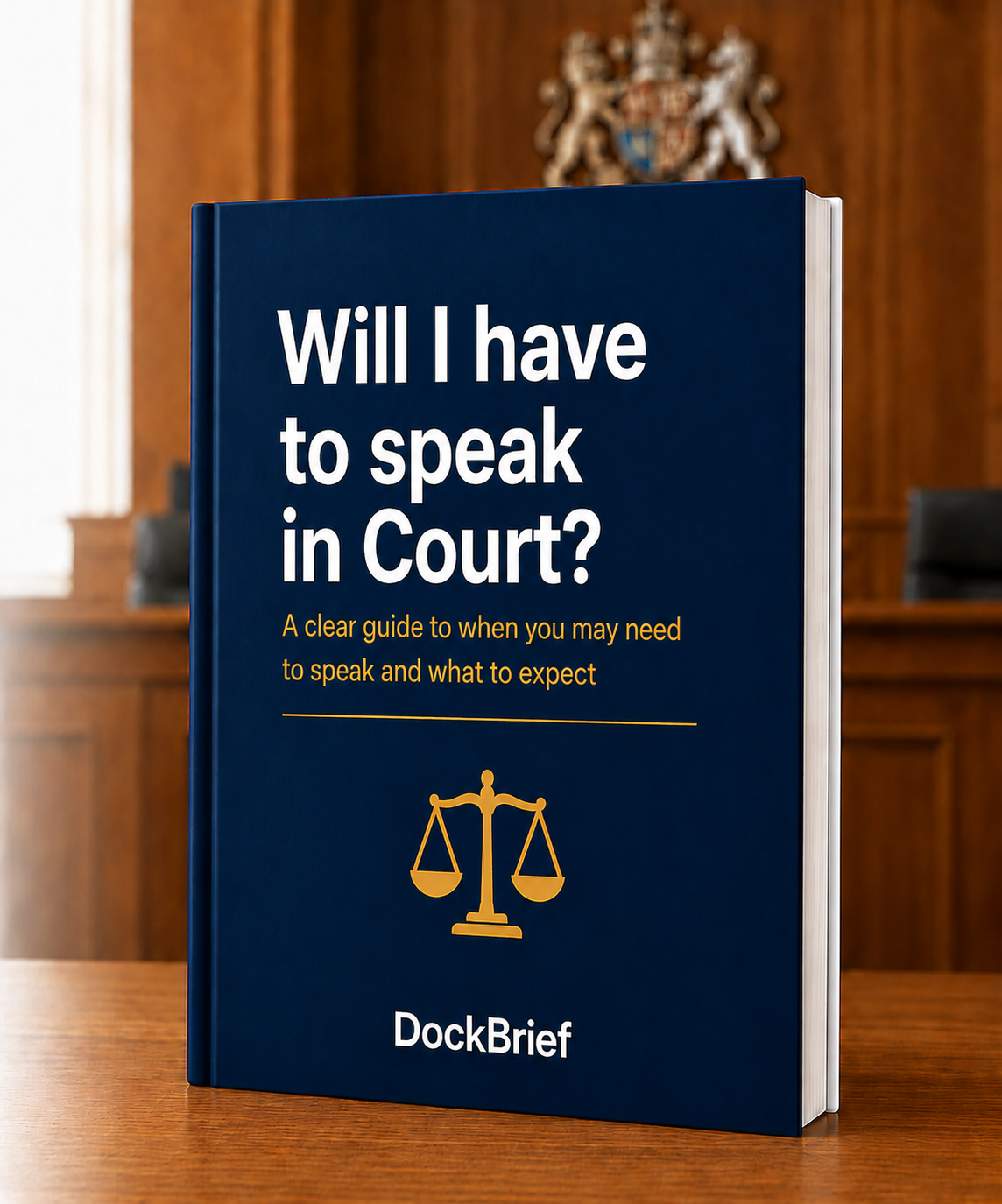 Book titled "Will I have to speak in Court?" on a wooden table, with a courtroom background and a scale of justice illustration on the cover.