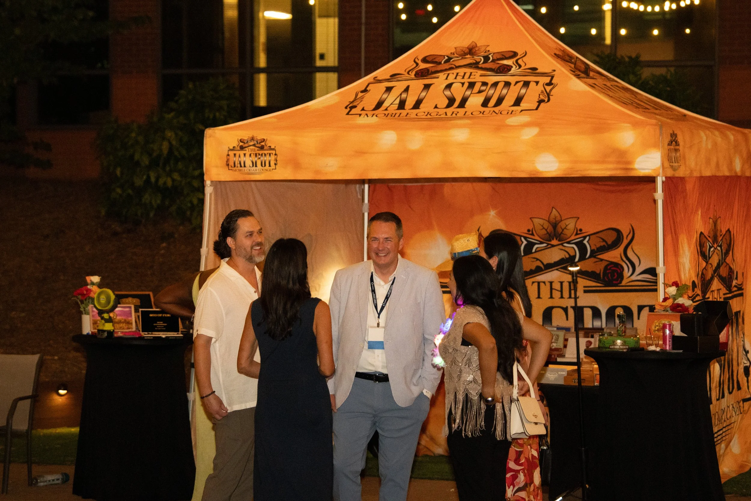 group of people talking in-front of cigar lounge tent
