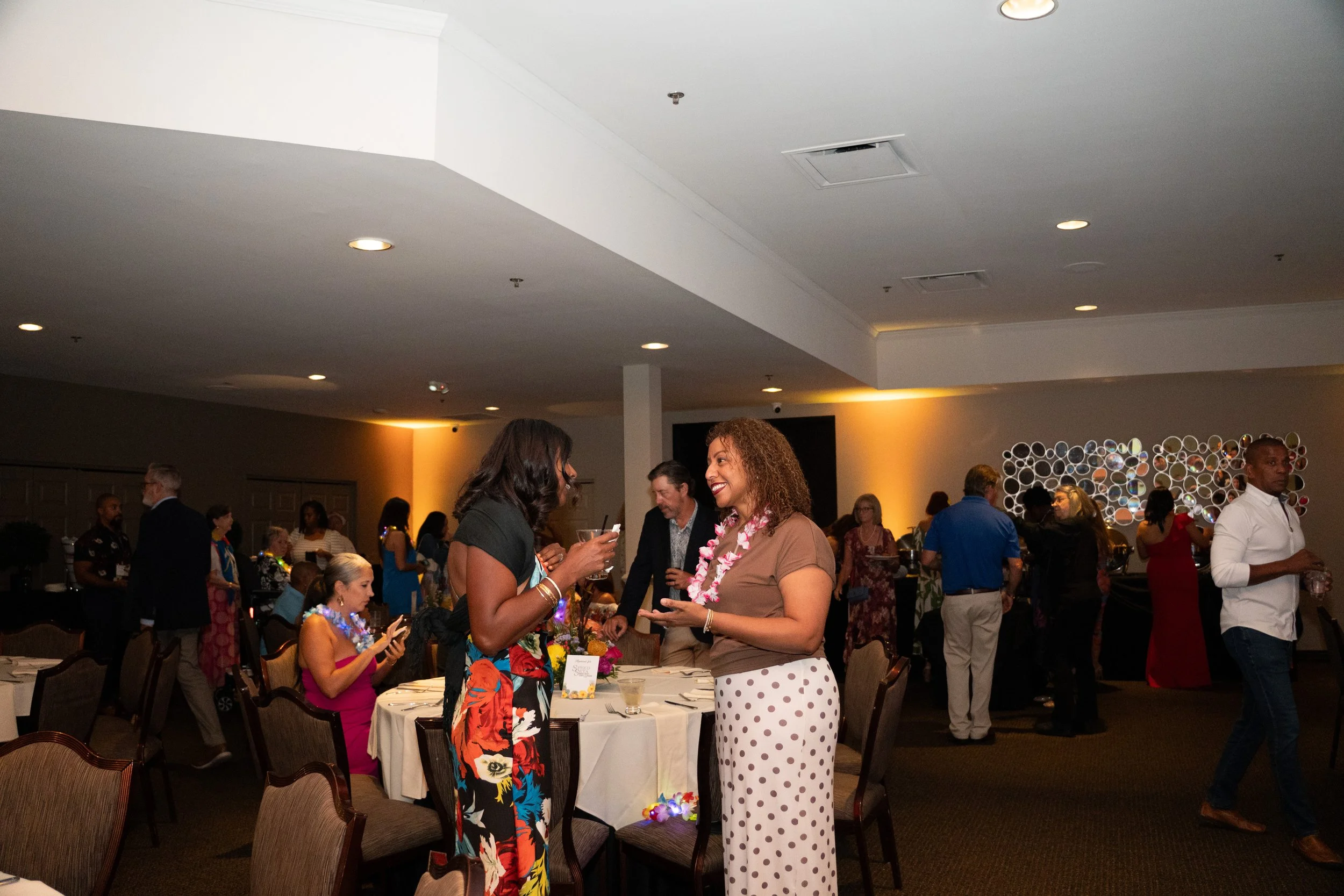 two women conversating at party