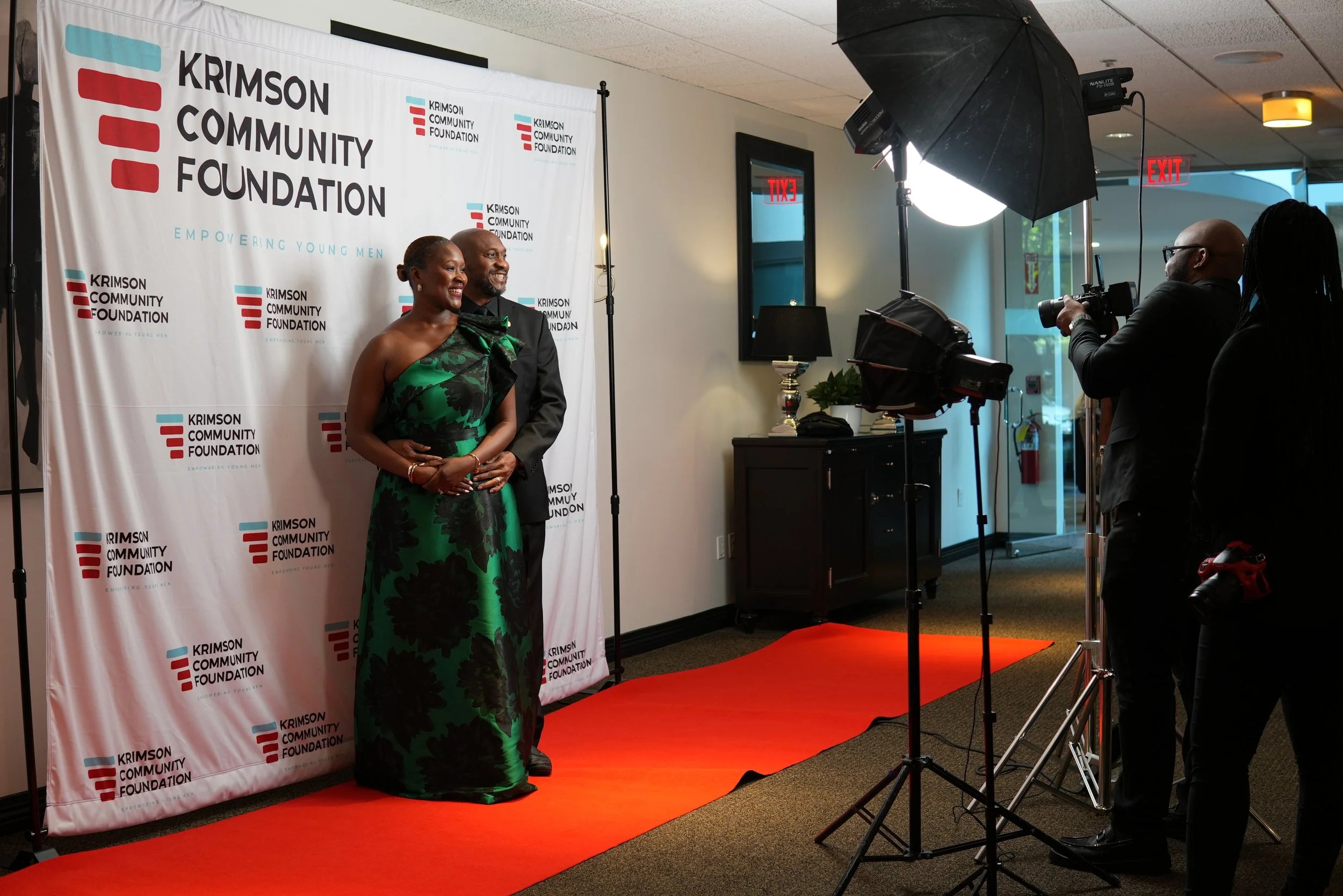 couple poses for red carpet photo at non-profit gala