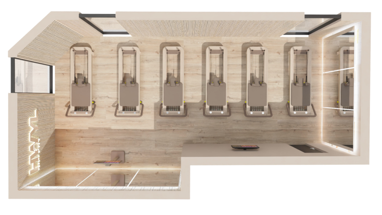 Top-down view of a modern computer lab with seven workstations, two chairs, and digital devices on a light wooden floor with minimal decoration.