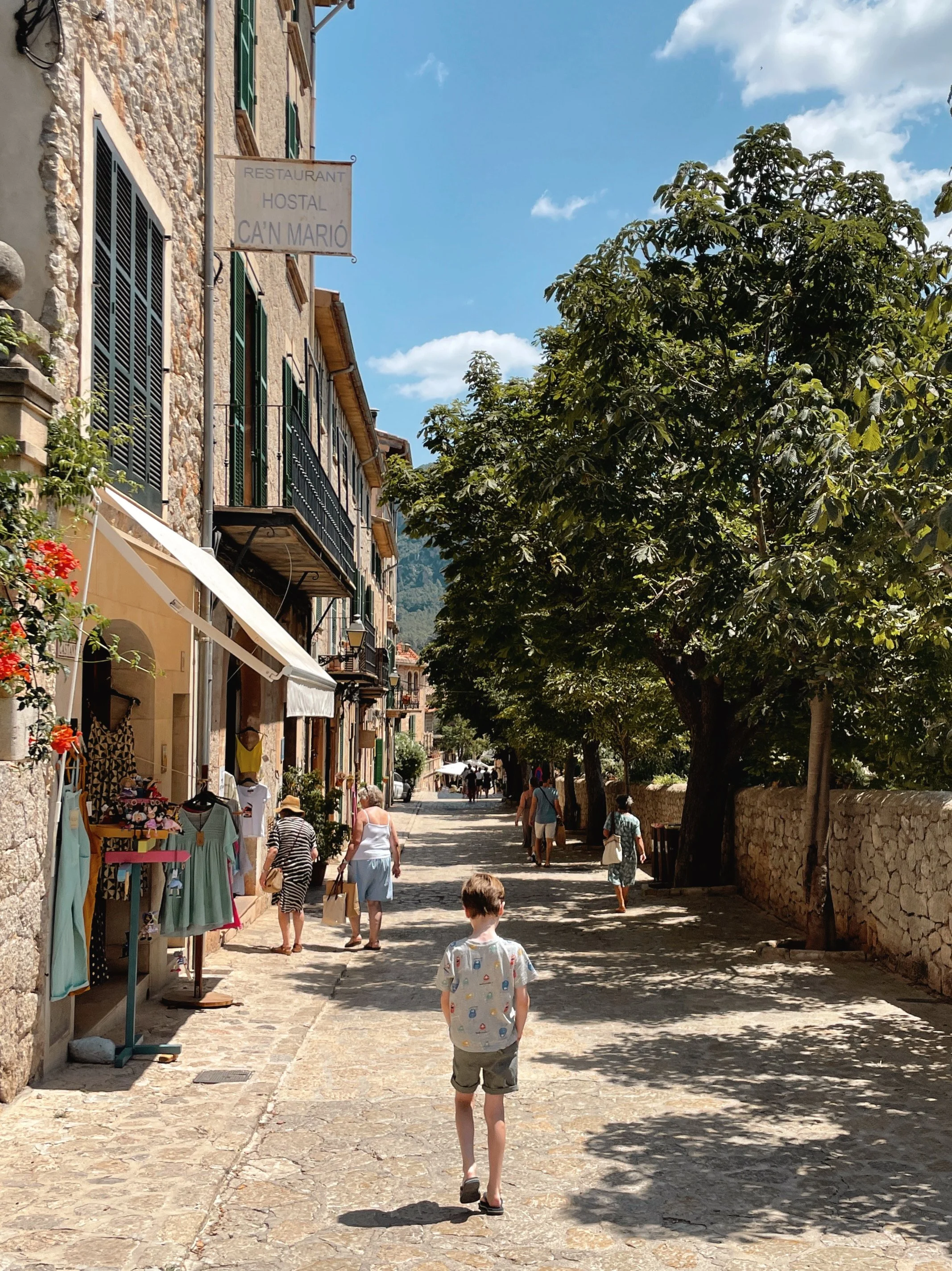 Boy walking along the cobbled shopping streets on Valldemossa