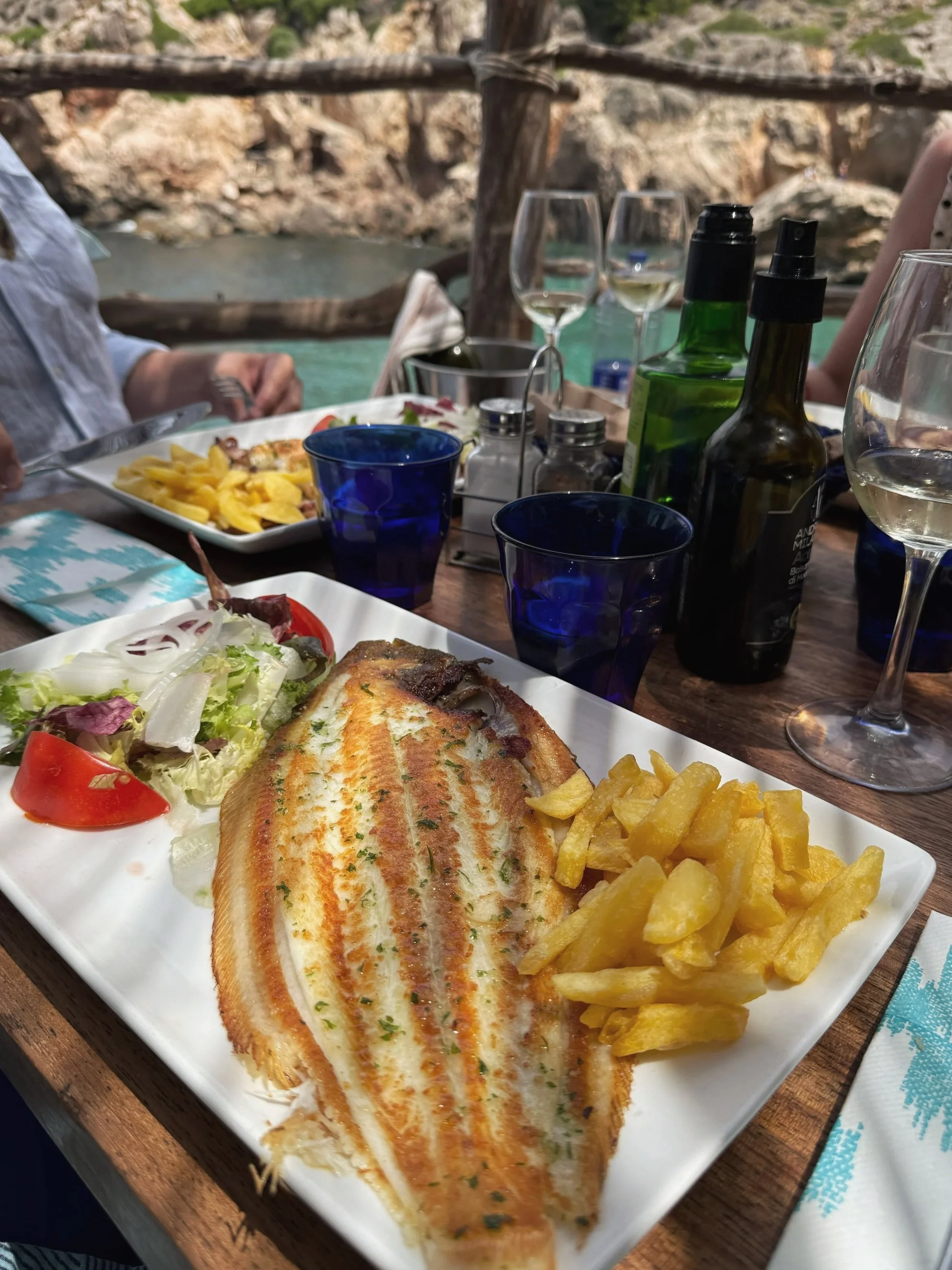 Grilled fresh fish for lunch above jade-coloured waters at Ca's Patró March in Cala Deià, Mallorca