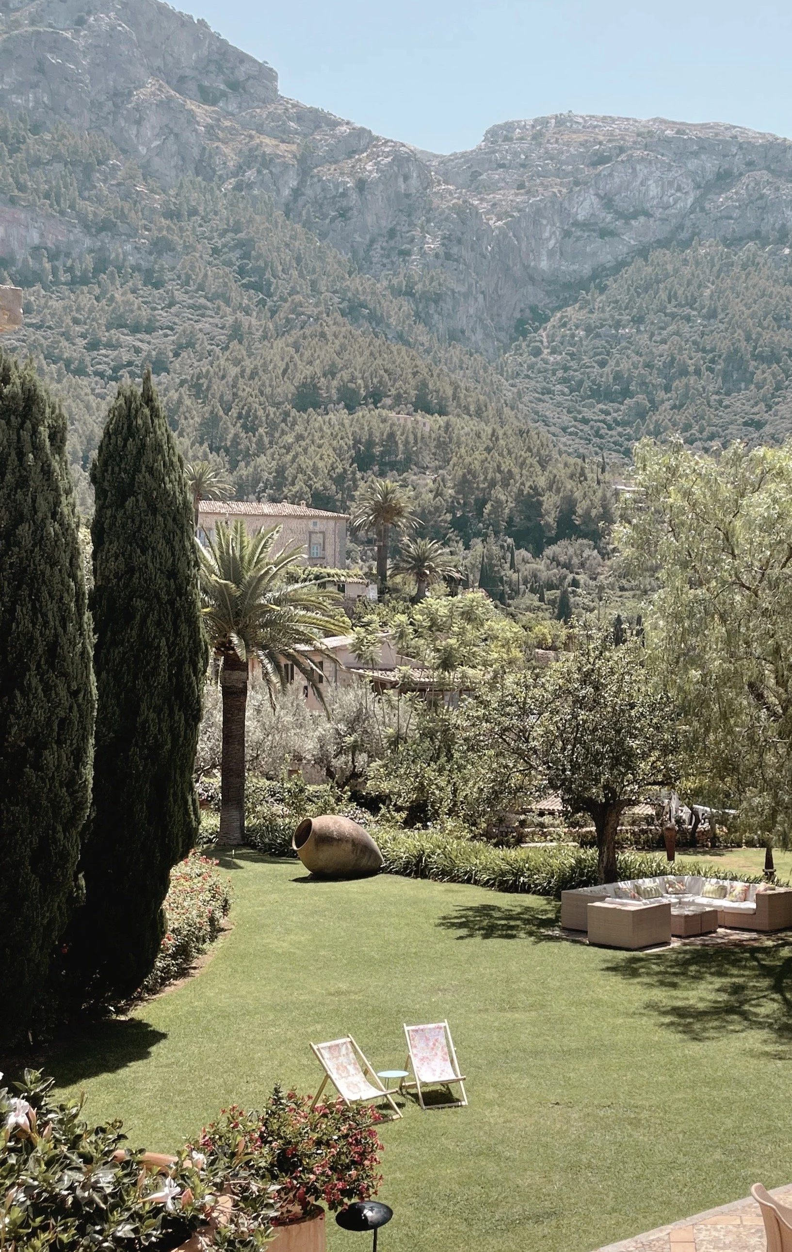 The manicured garden of La Residencia, Deià, with the Tramuntana mountains beyond