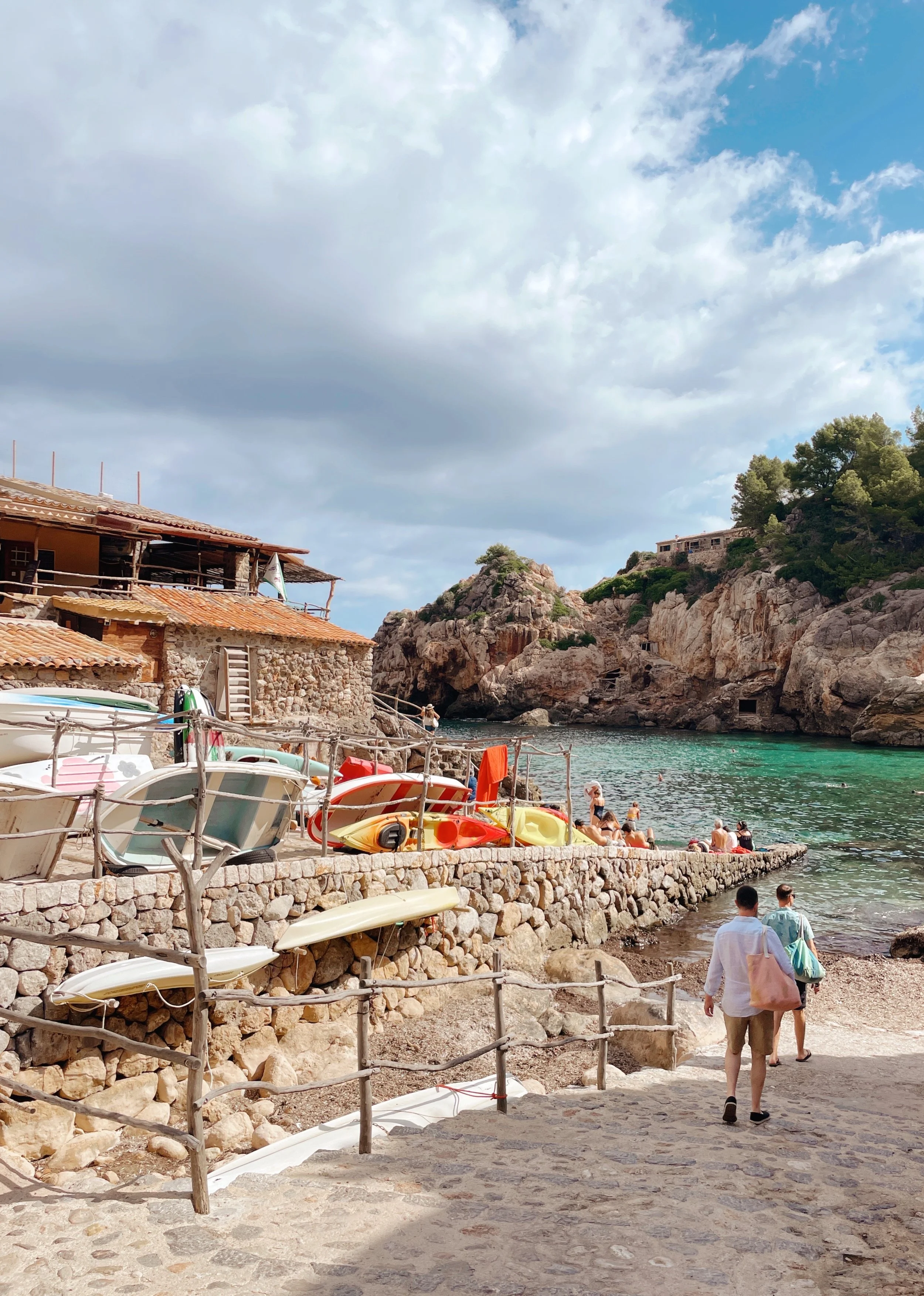 The beautiful cove of Cala Deiá greets you with the view of emerald green sea
