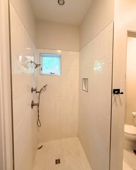Mims Construction crew performing bathroom demolition and electrical rerouting in North Chattanooga TN home