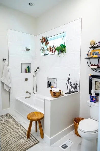 Completed luxury bathroom remodel with tile floor custom tub combo and hung barn door by Mims Construction