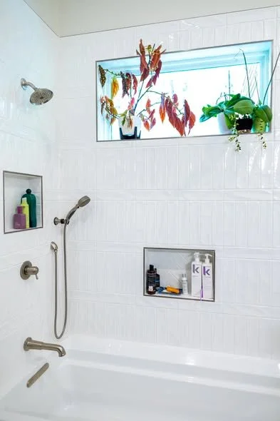 Completed luxury bathroom remodel with tile floor custom tub combo and hung barn door by Mims Construction