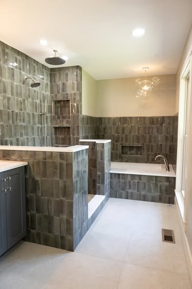 Close up of custom shower tile layout and transition detail by Mims Construction in luxury Riverview bathroom