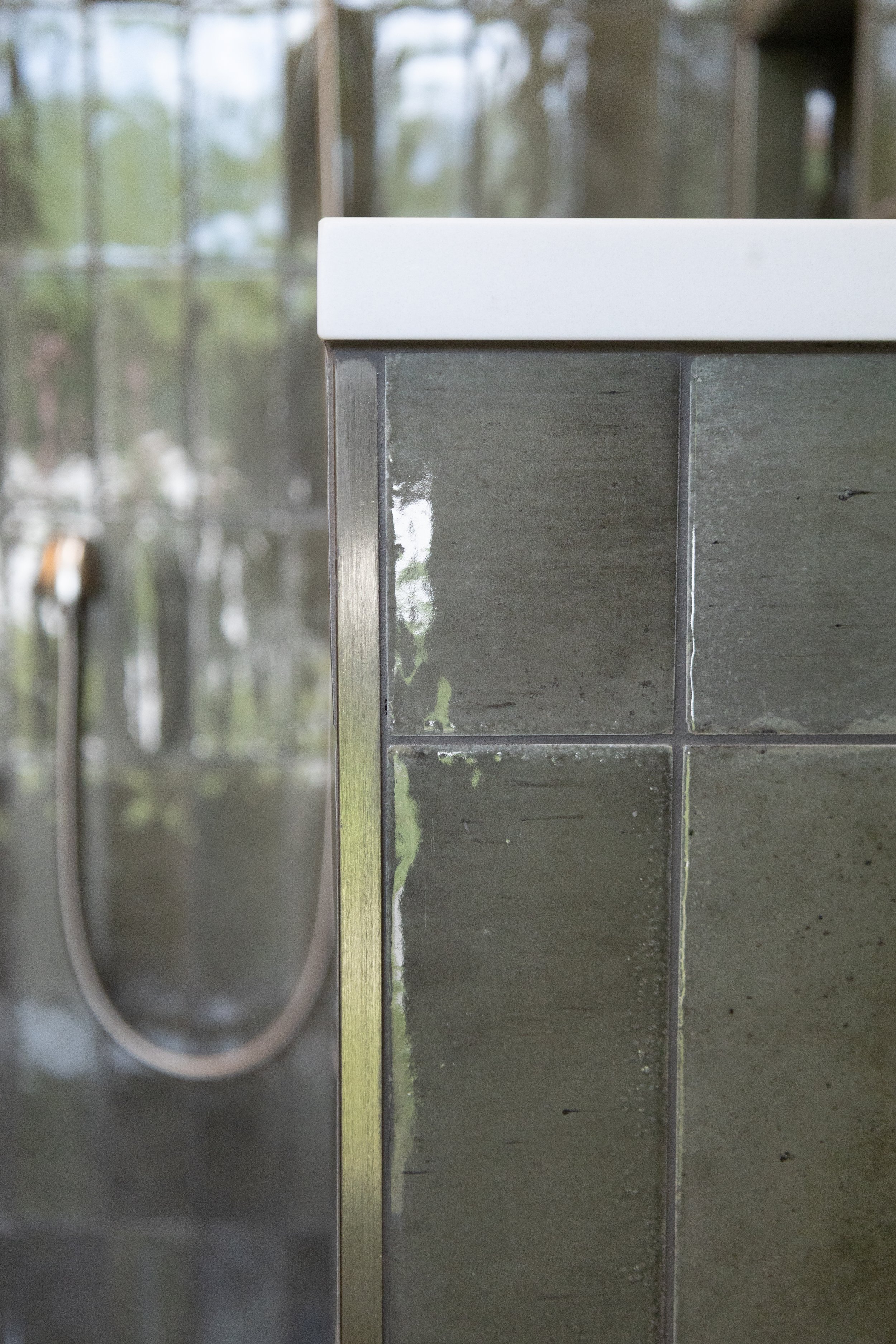 Close up of custom shower tile layout and transition detail by Mims Construction in luxury Riverview bathroom