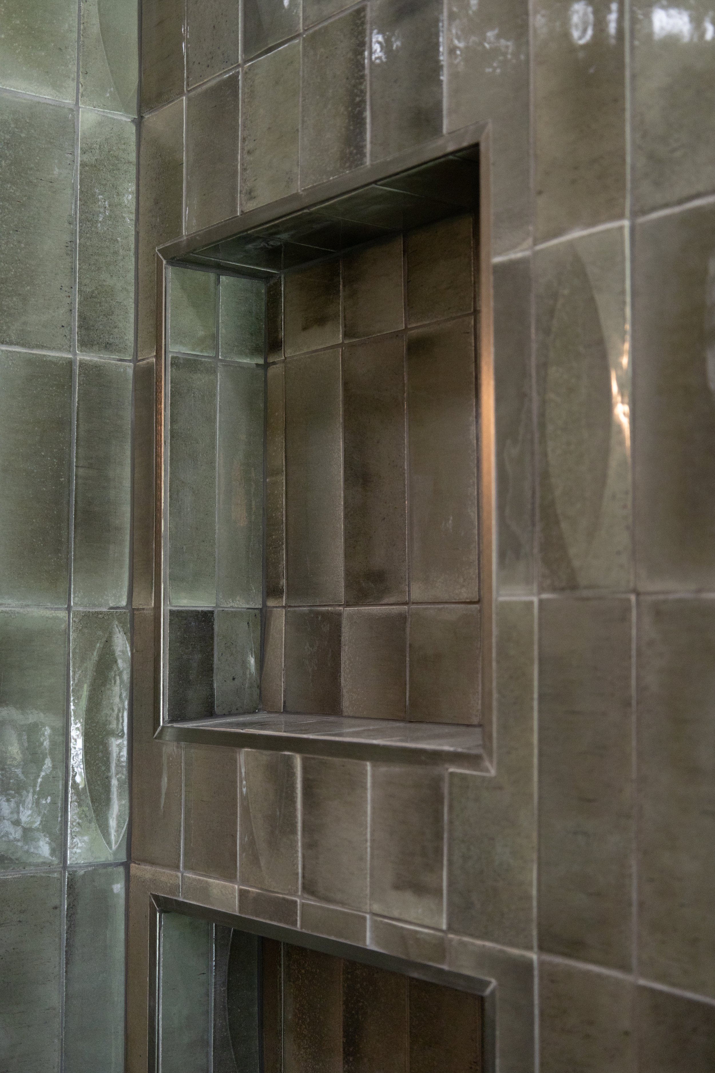 Close up of custom shower tile layout and transition detail by Mims Construction in luxury Riverview bathroom