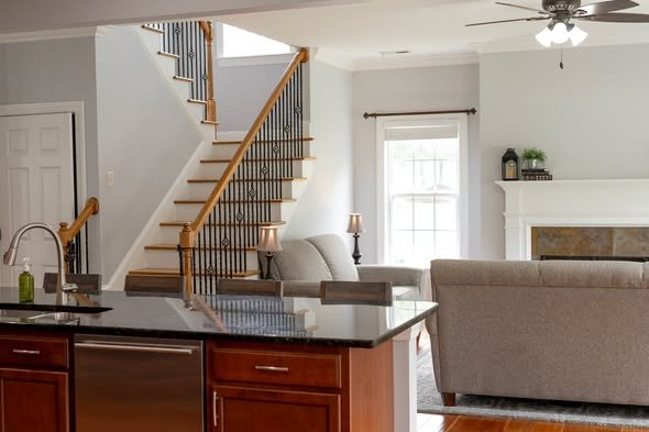 Completed pre-sale home refresh featuring updated lighting painted cabinets and refinished flooring by Mims Construction