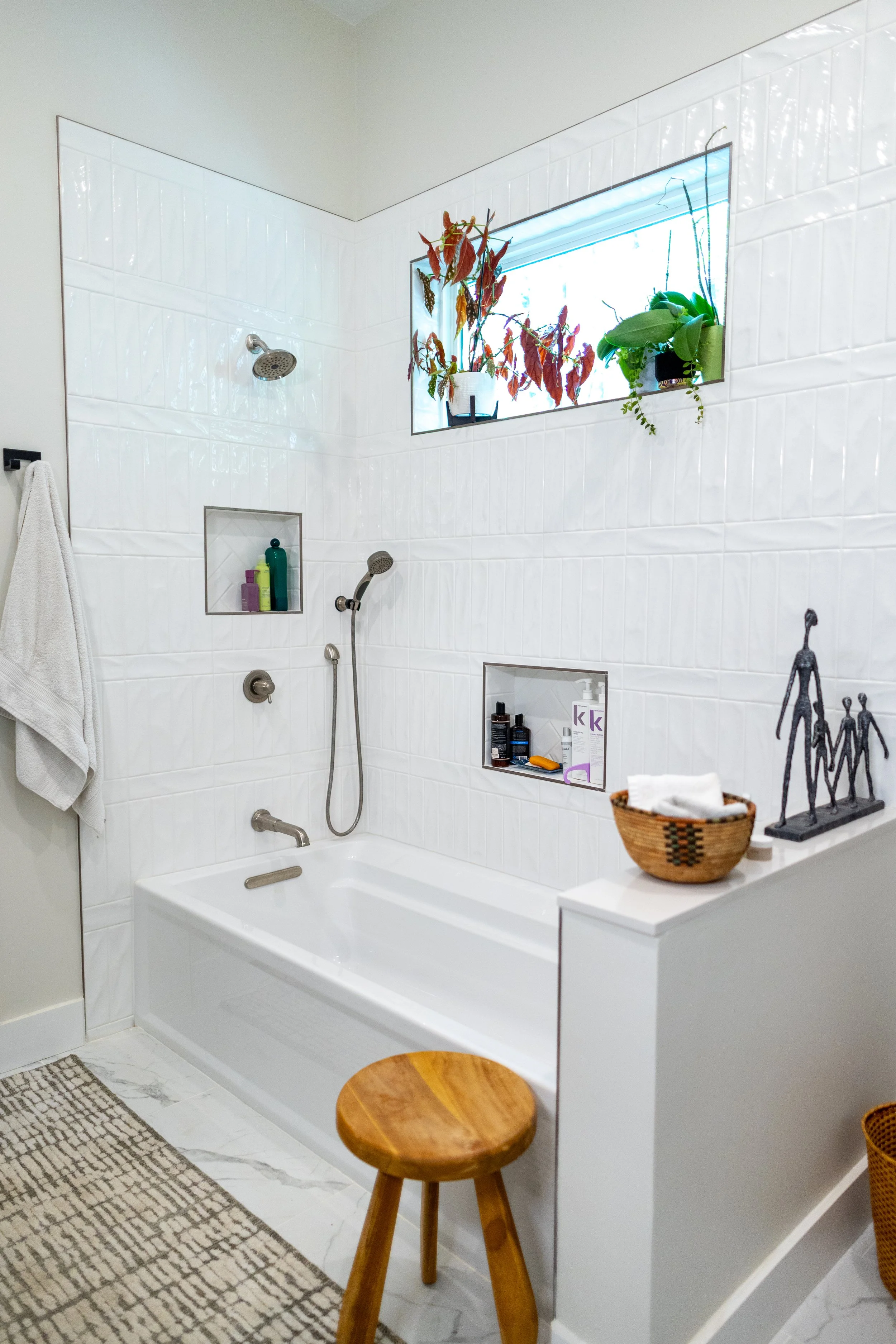 Custom residential bathroom renovation in the historic North Shore Riverview neighborhood of Chattanooga TN, modern white tile walk-in shower, a built-in tub configuration, and precision-engineered recessed tiled shelf niches.